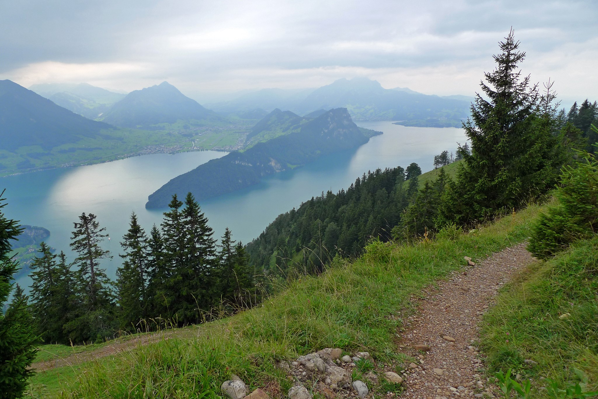 Lake and mountains with a hiking trail in Switzerland HD Wallpaper