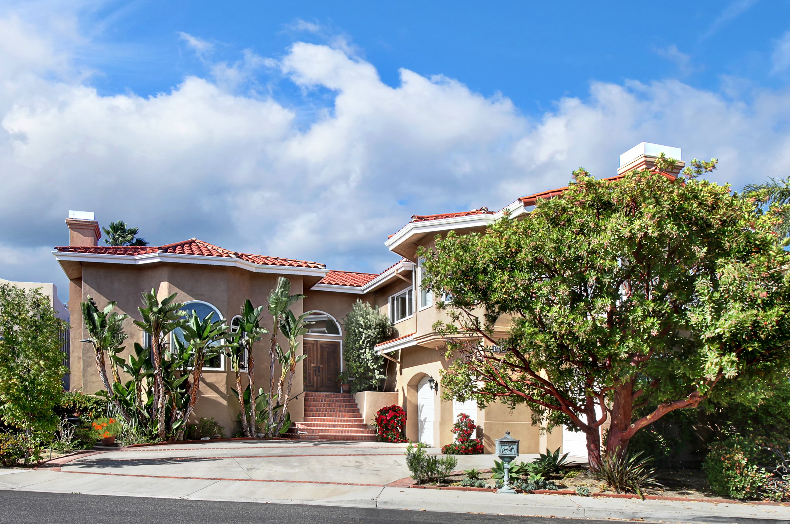 Two-story house with red tile roof and landscaping HD Wallpaper