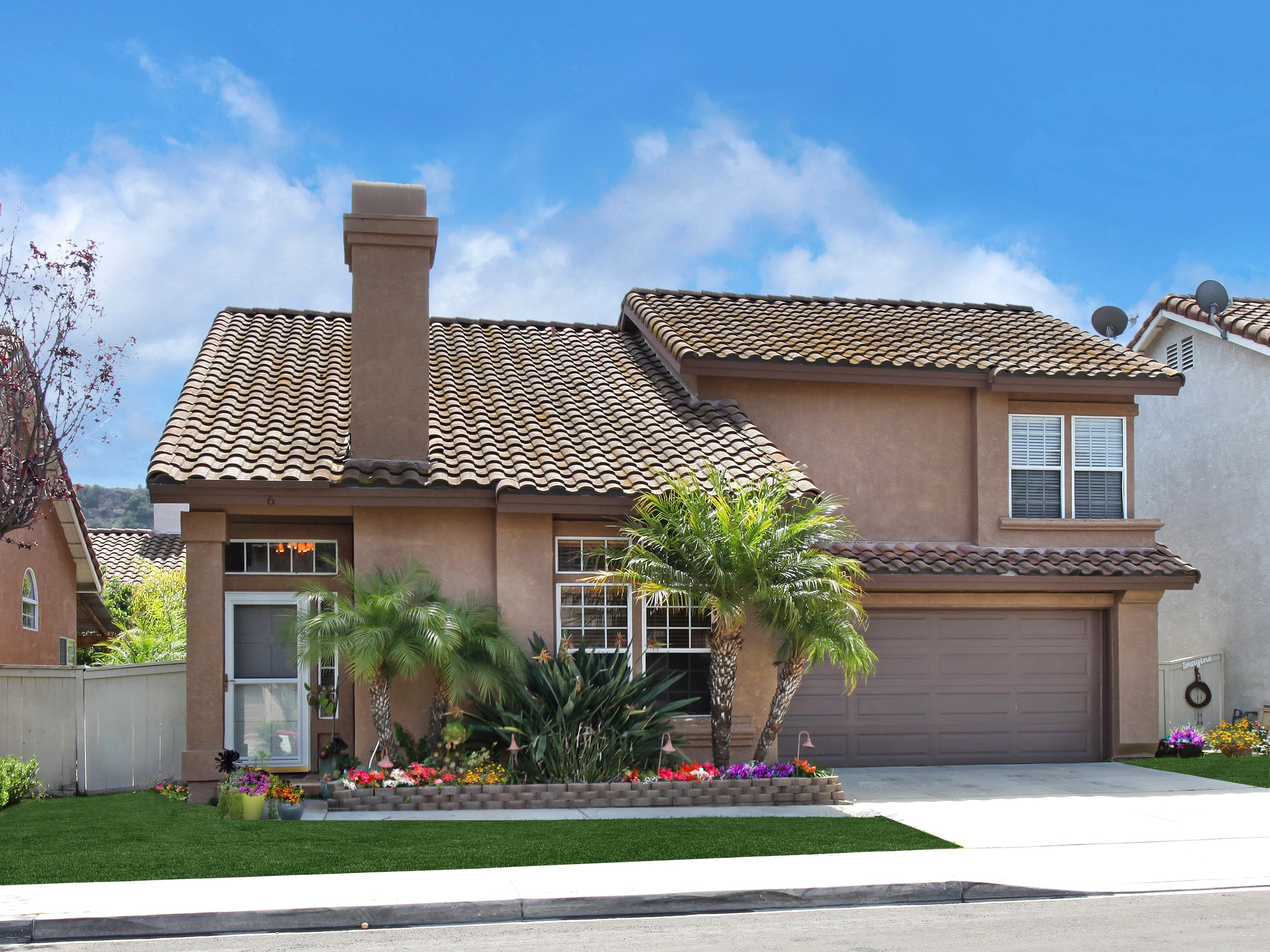 Two-story house with tile roof and palm trees HD Wallpaper