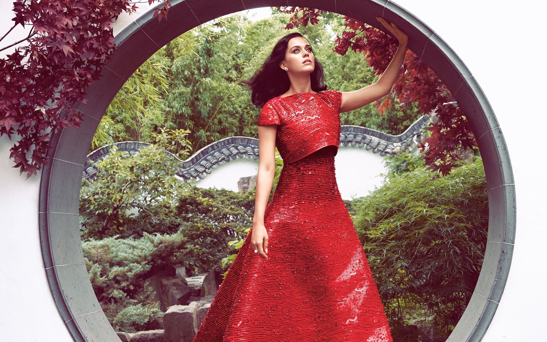 Katy Perry in a red dress in a garden HD Wallpaper