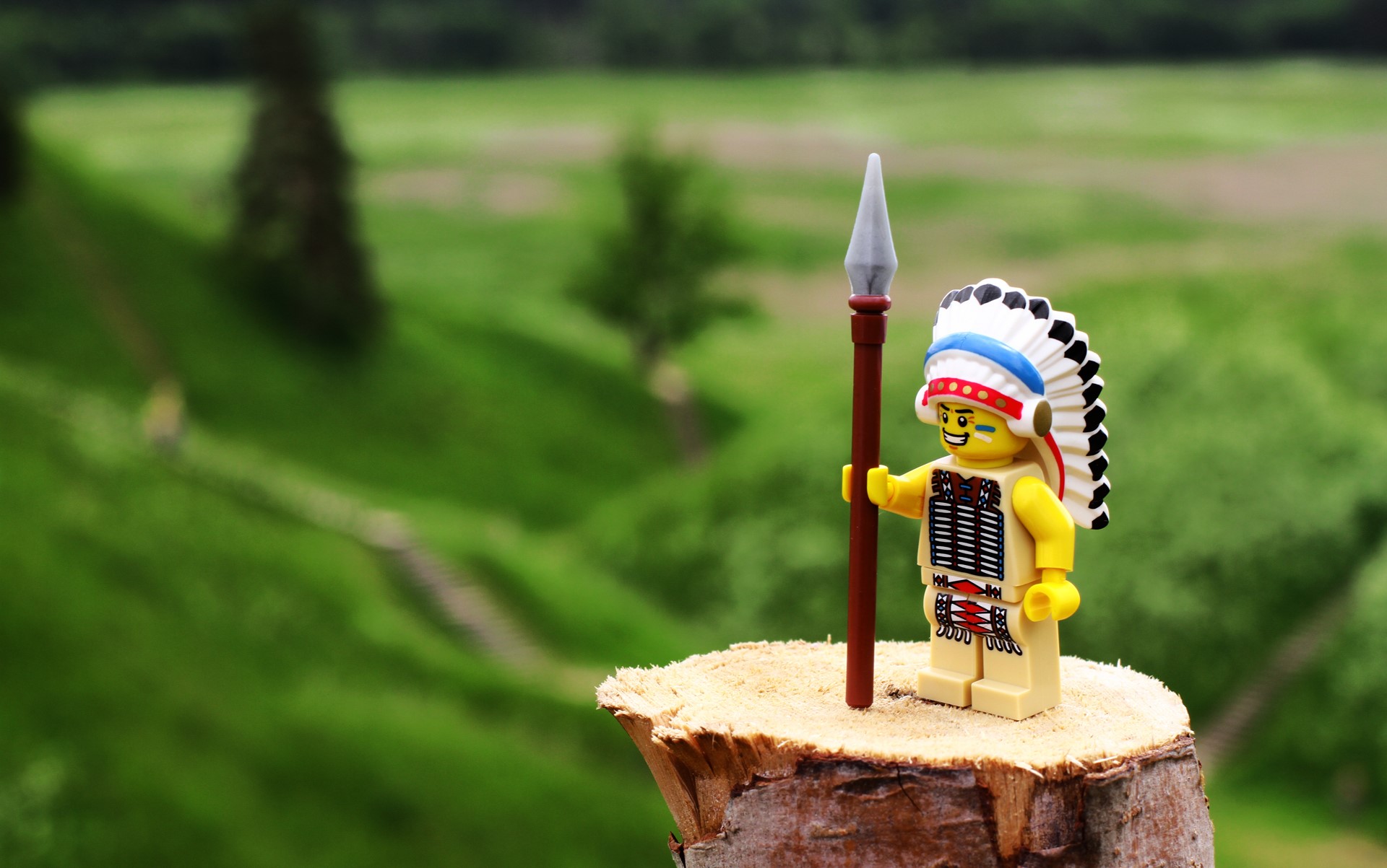 Lego Native American figure with spear on log HD Wallpaper