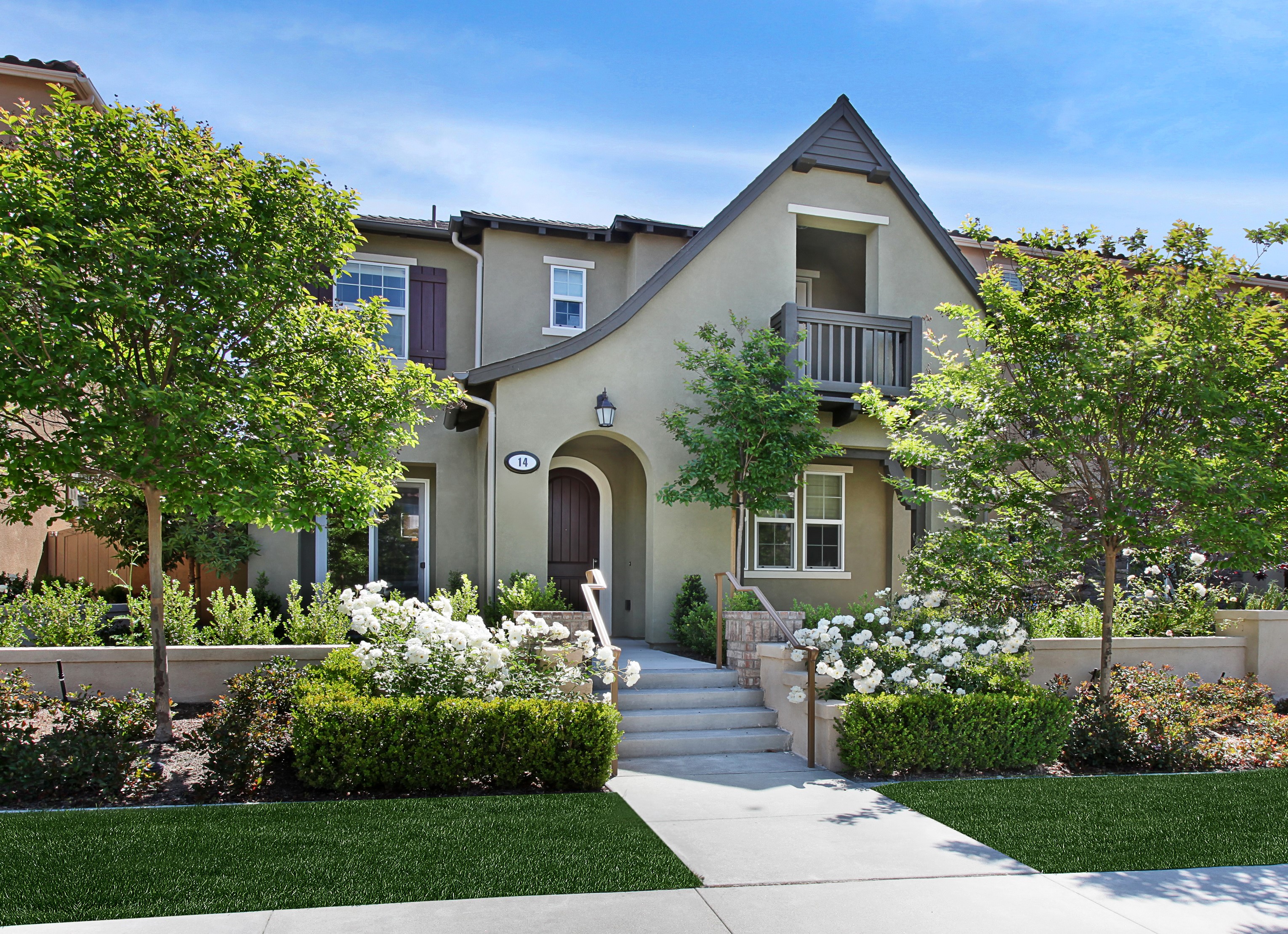 Two-story house with landscaping and trees HD Wallpaper