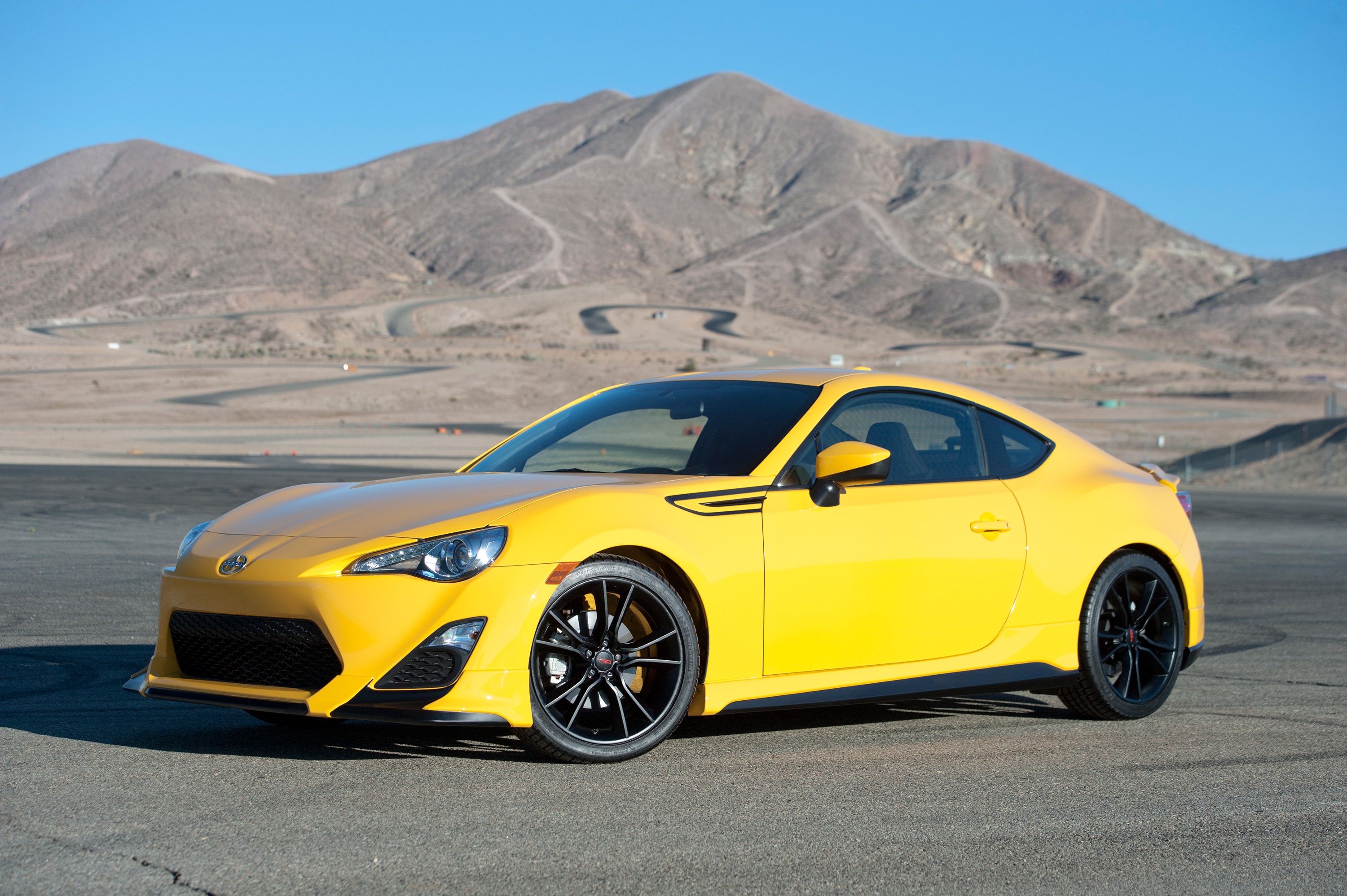 Yellow 2014 Scion FR-S Release Series 1.0 on a Racetrack HD Wallpaper
