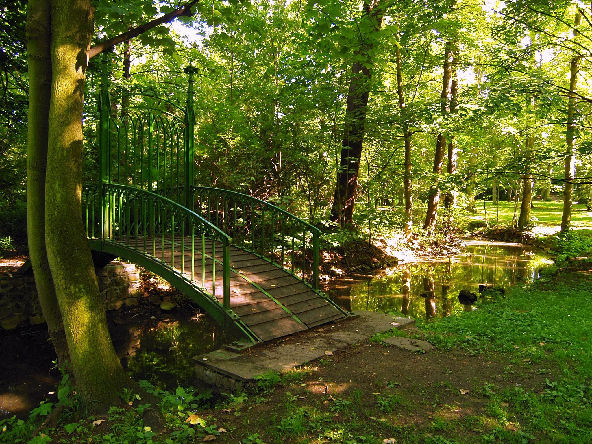 Green bridge over a stream in a park in Teplice, Czech Republic HD Wallpaper
