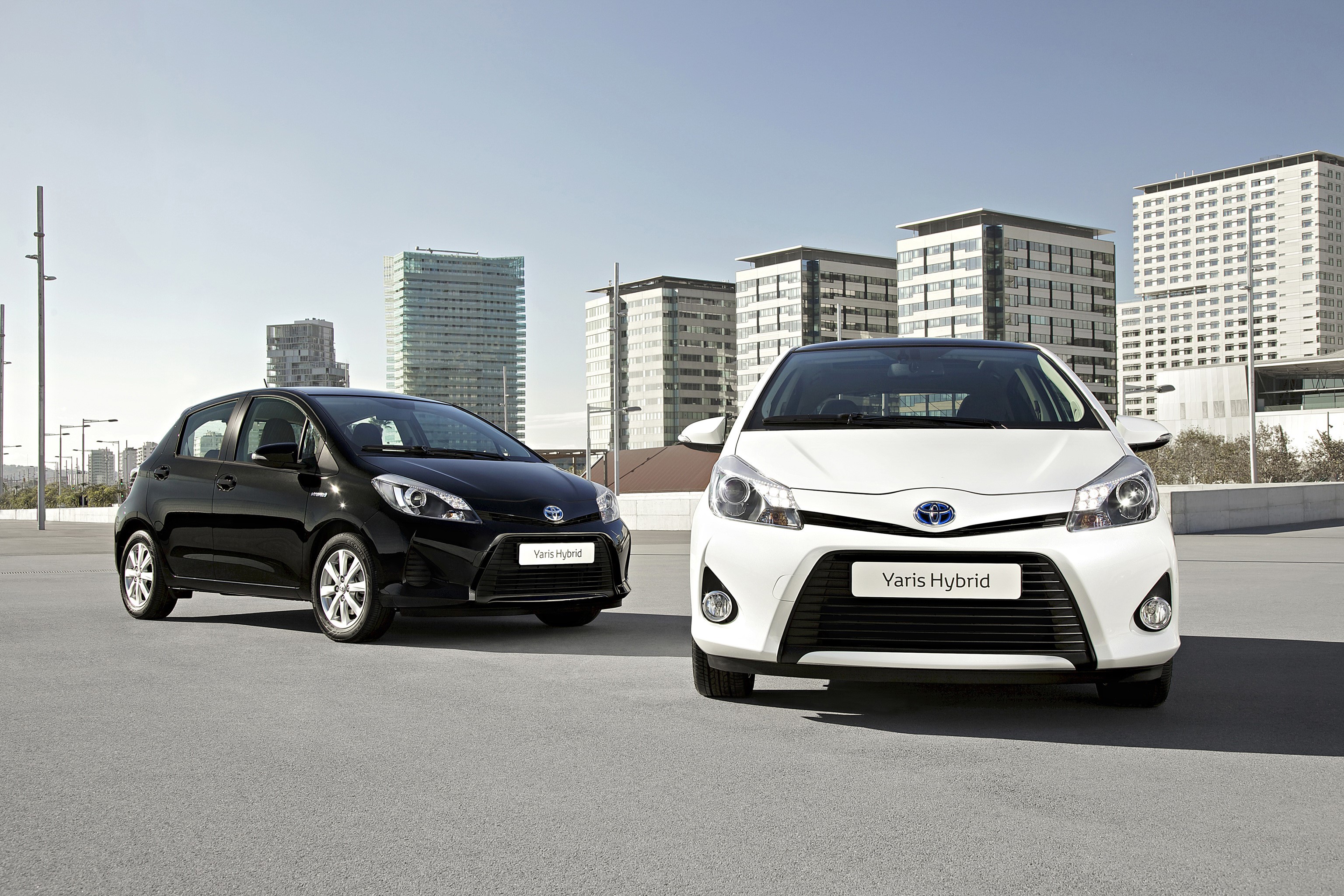 Two Toyota Yaris Hybrid cars parked outdoors HD Wallpaper