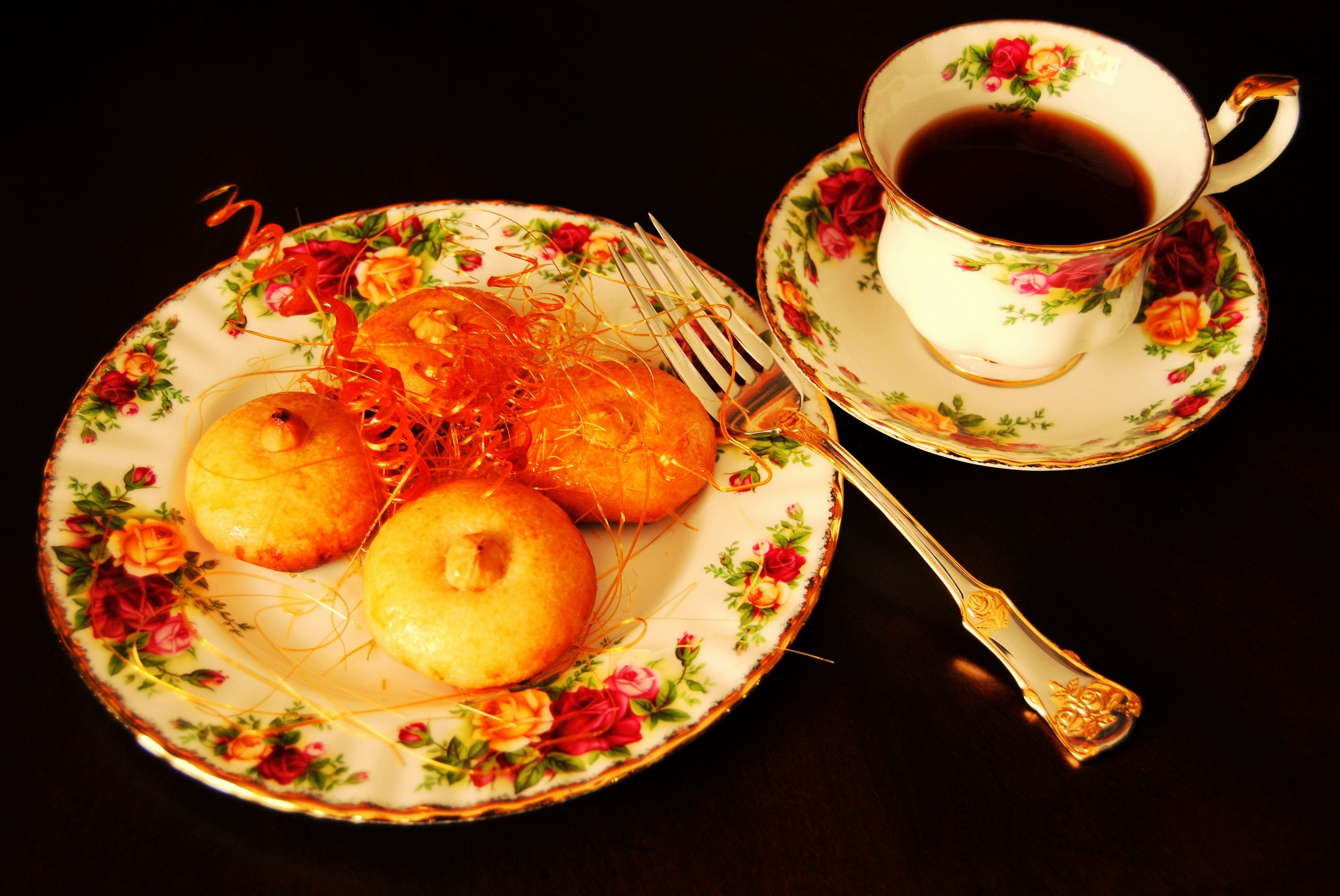 Tea cup and saucer with pastries on a plate HD Wallpaper