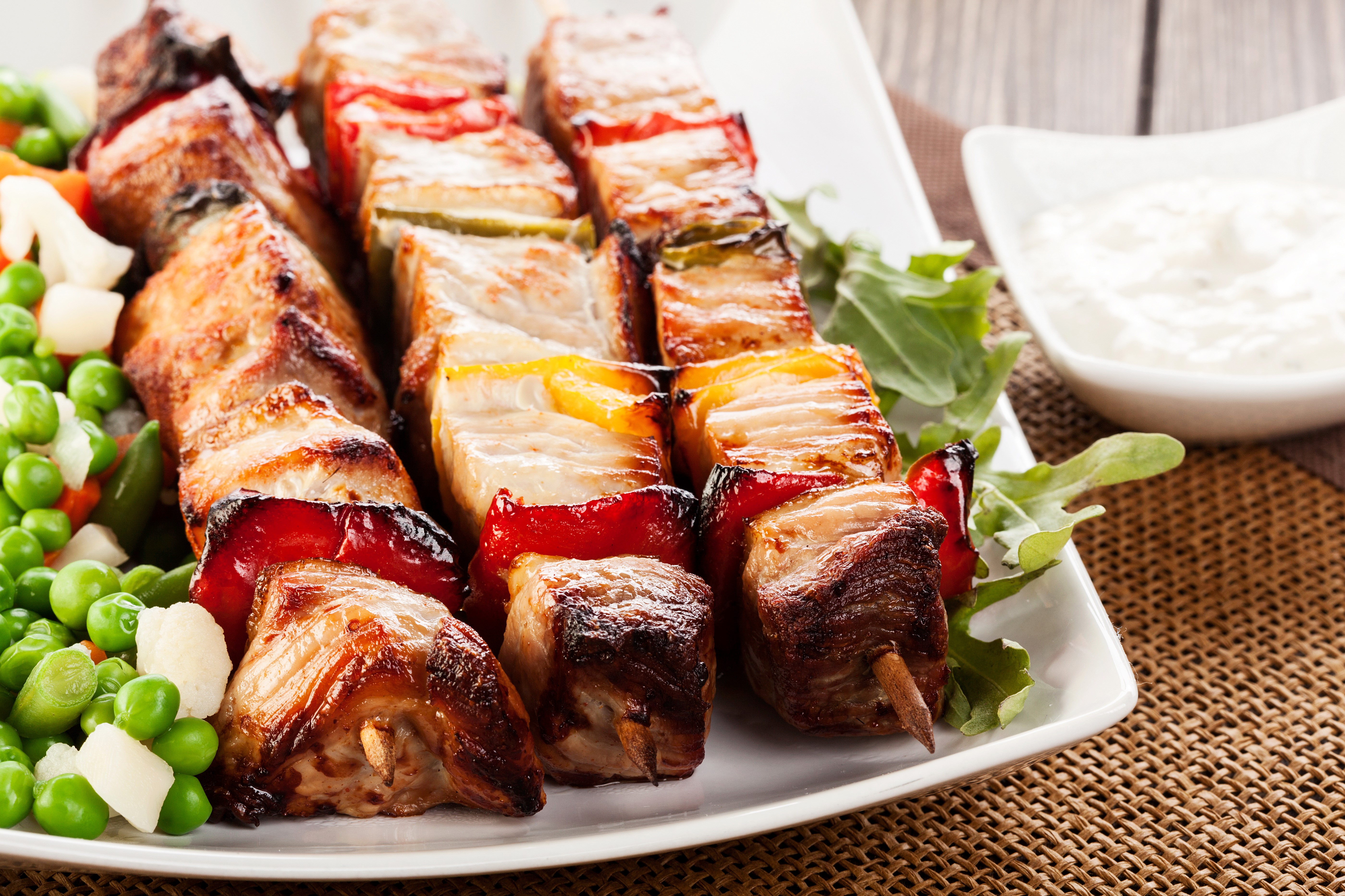Meat shashlik on a plate with vegetables and dip HD Wallpaper
