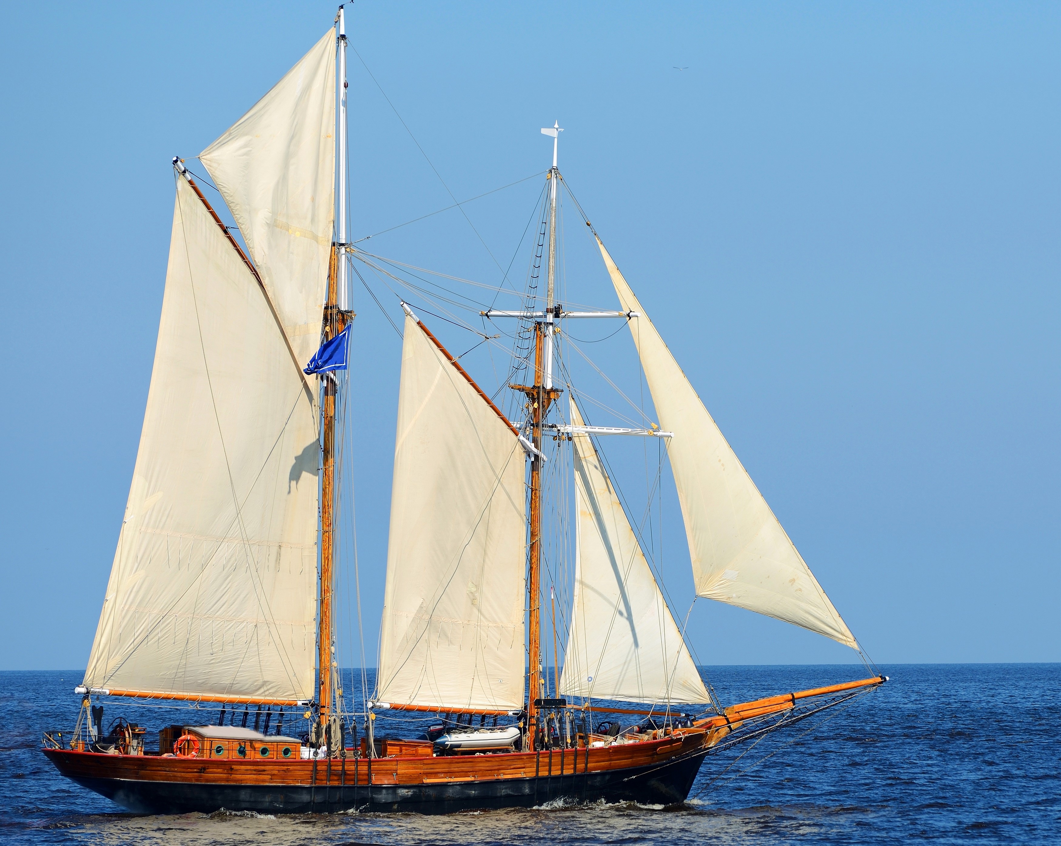 Wooden sailing ship with white sails on the sea HD Wallpaper