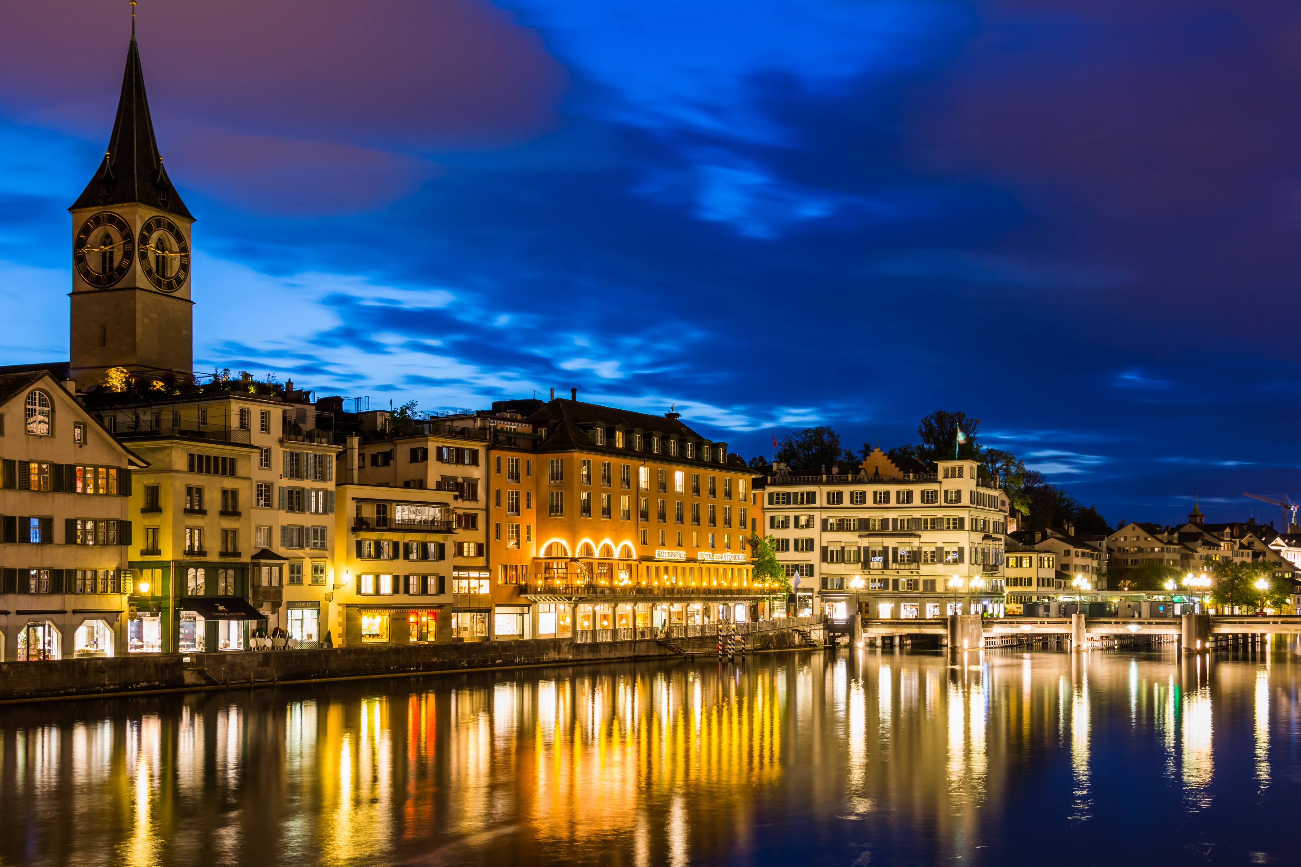 Zurich at night with clock tower and river HD Wallpaper