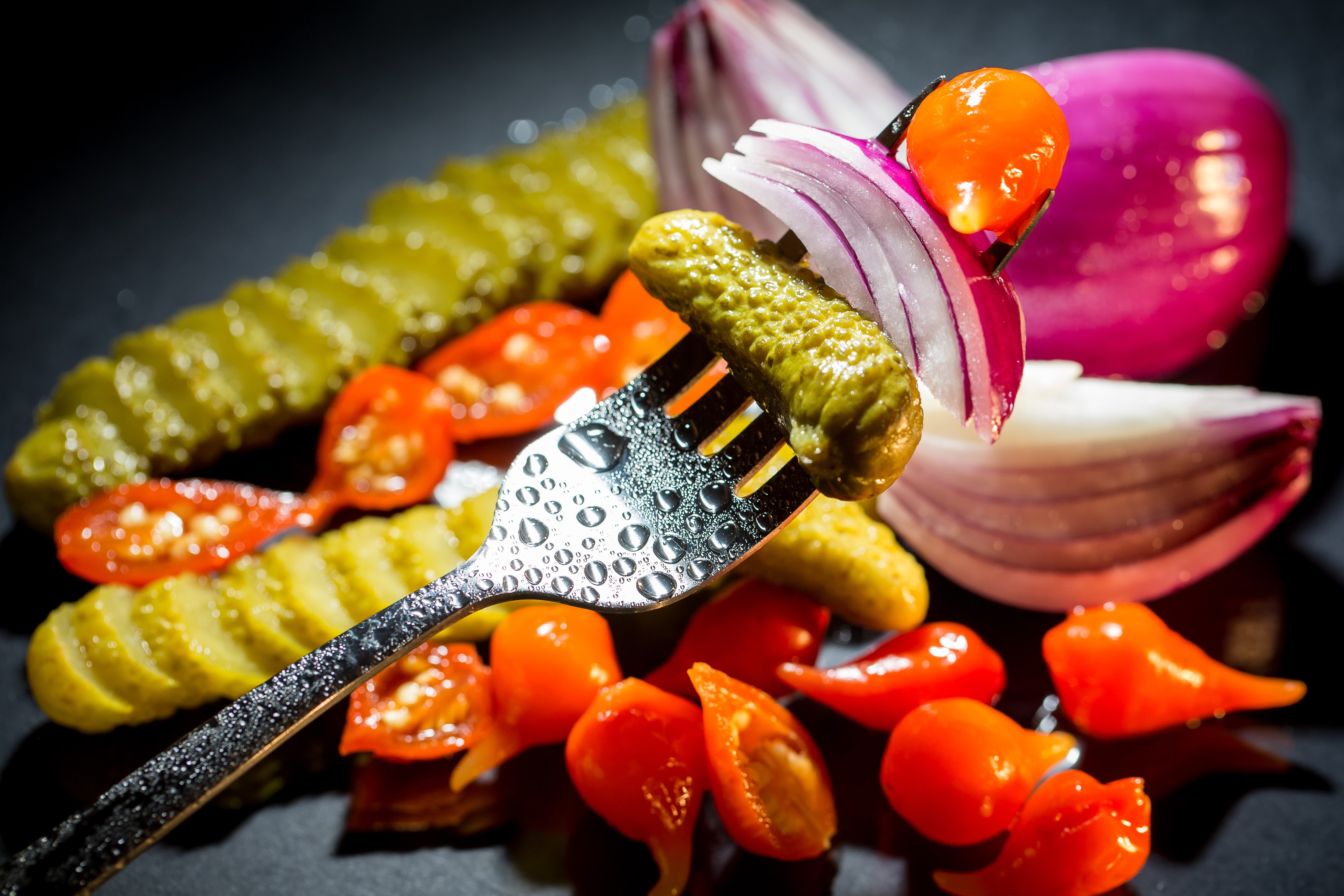 Pickles, Tomatoes, Onion, and Peppers on a Fork HD Wallpaper