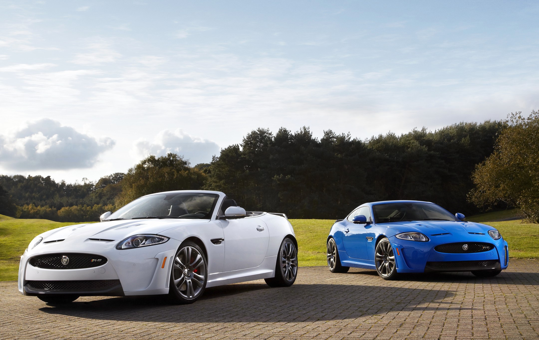 Two Jaguar XKRs, one white convertible and one blue coupe HD Wallpaper