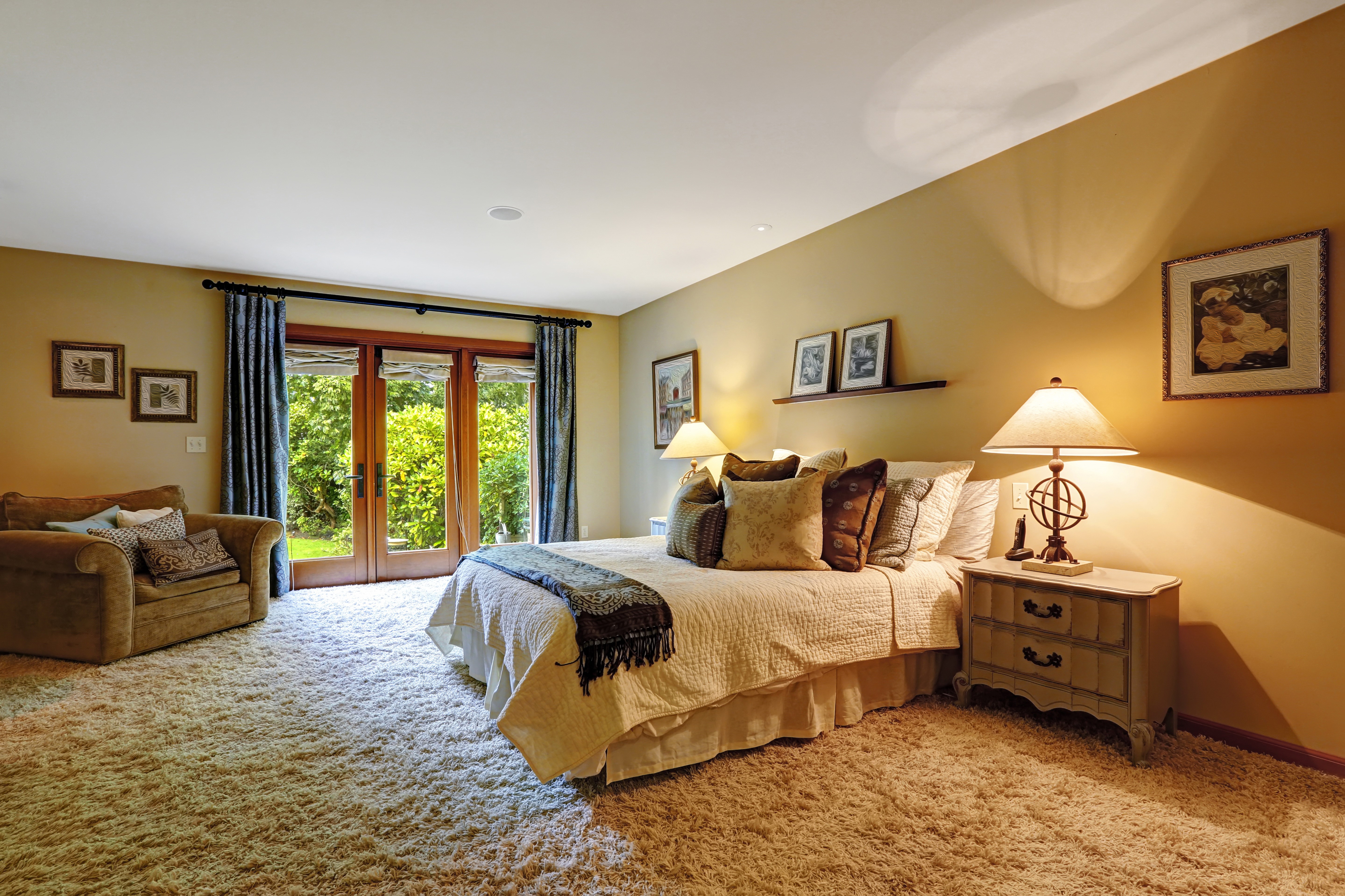 Bedroom with bed, armchair, and French doors HD Wallpaper