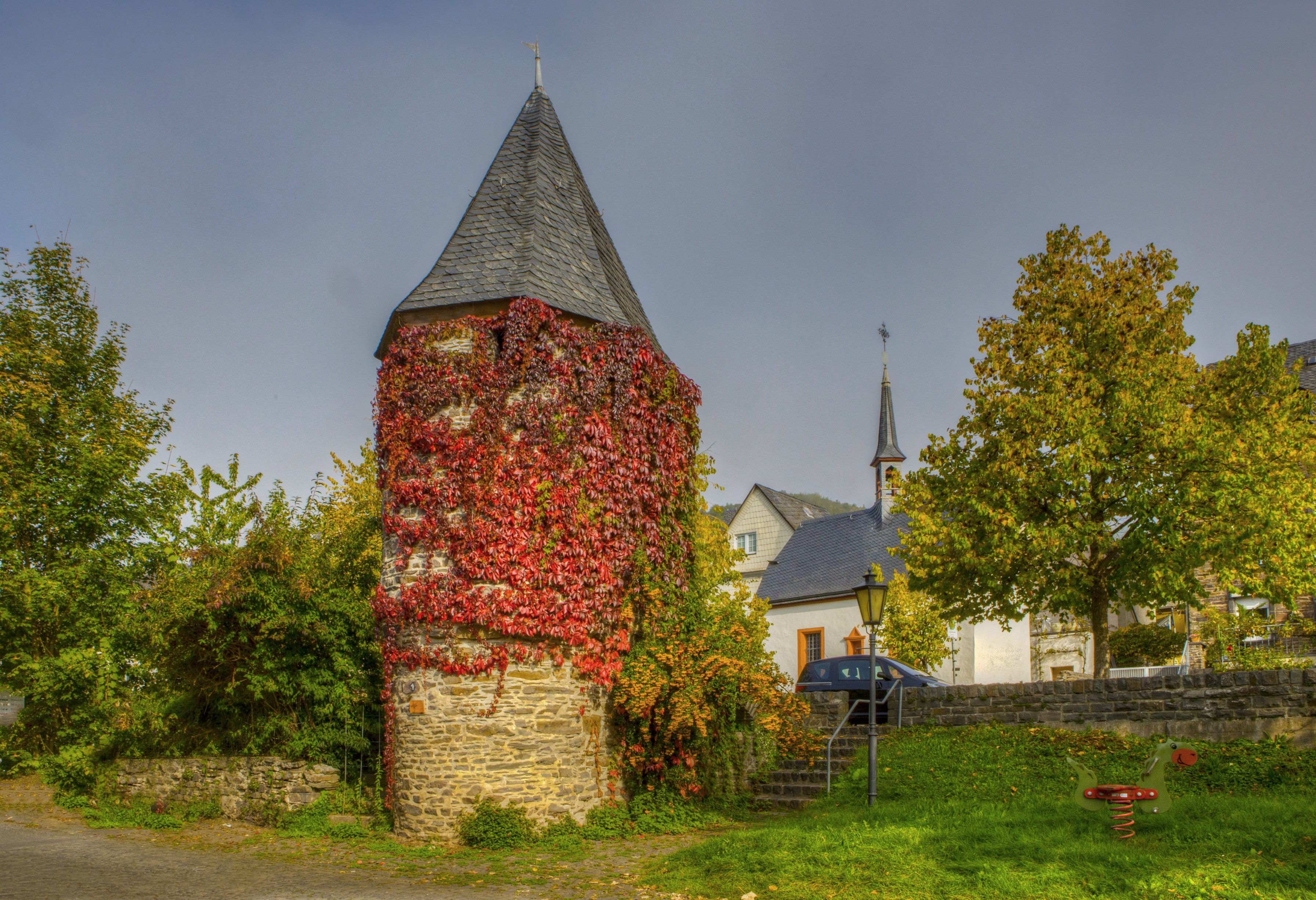 Stone tower covered in red ivy in Ediger-Eller, Germany HD Wallpaper