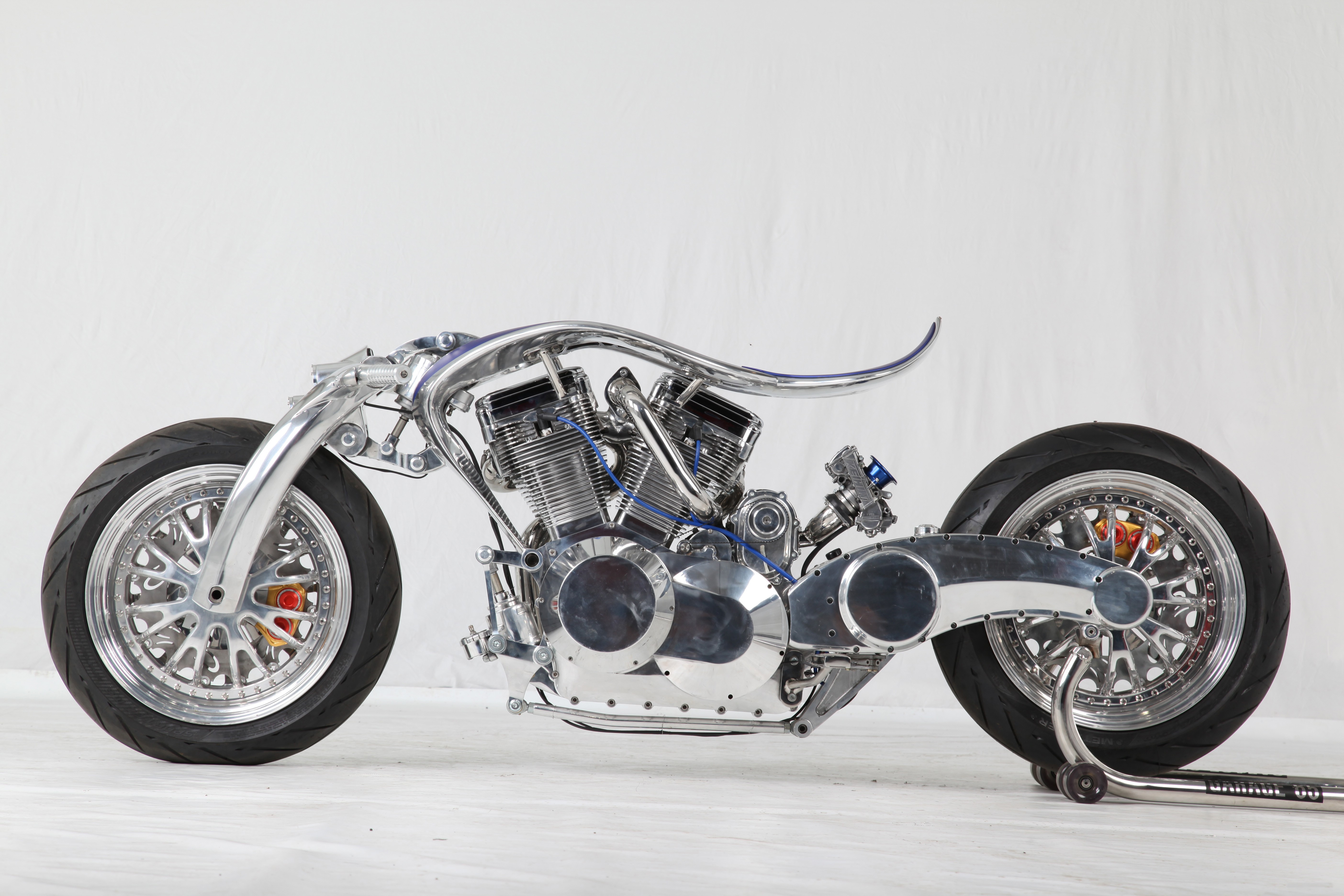 Custom motorcycle with chrome frame and V-twin engine HD Wallpaper