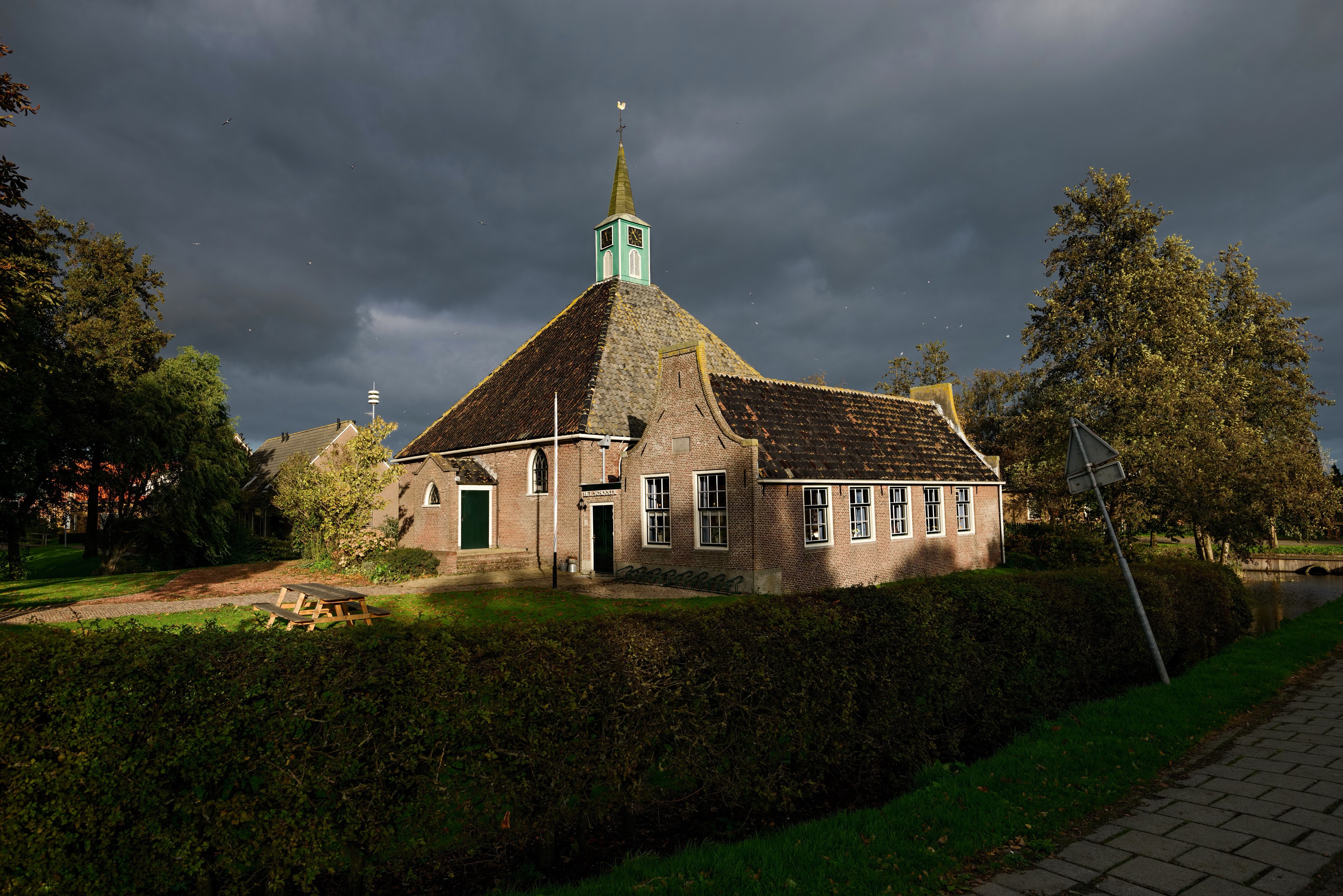 Church in Netherlands with dark clouds HD Wallpaper