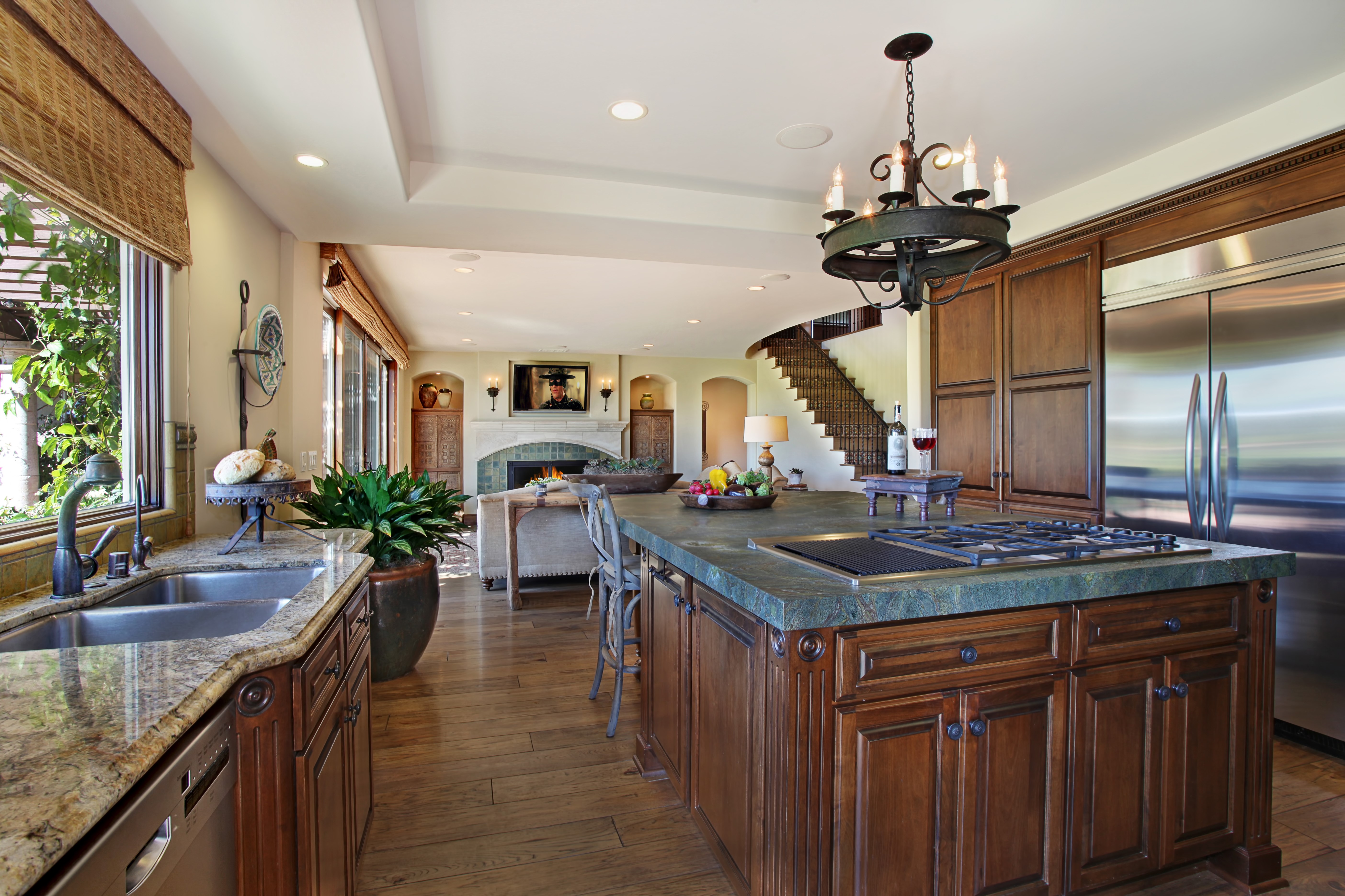 Kitchen with island, fireplace, and staircase HD Wallpaper