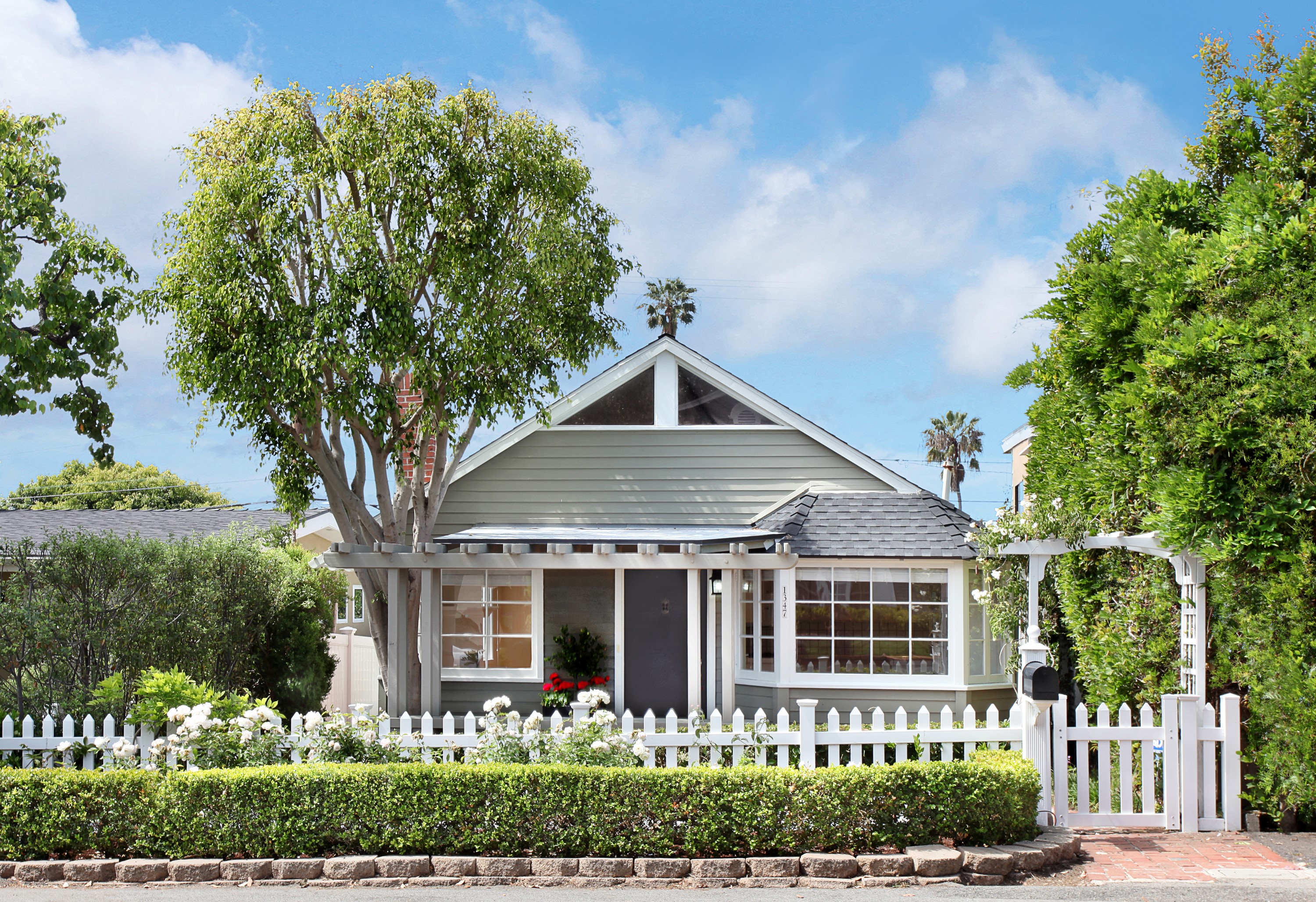 Green house with white picket fence and trees HD Wallpaper
