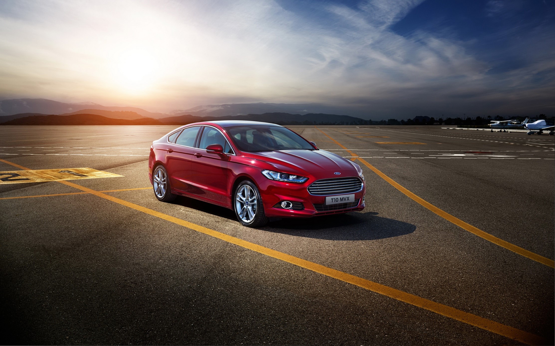 Red Ford Mondeo on an airport tarmac at sunset HD Wallpaper