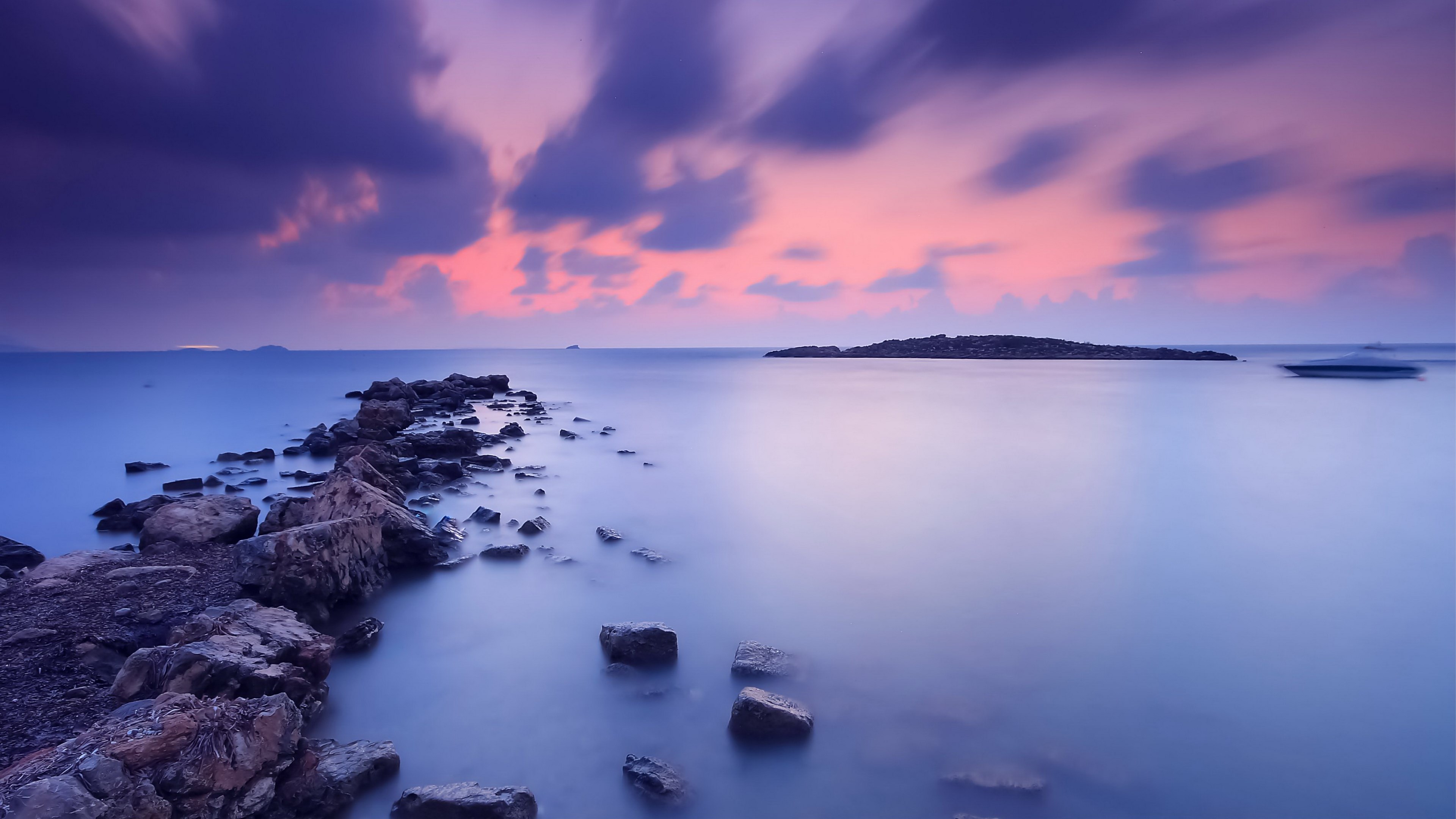 Long exposure of a rocky shore at sunset with clouds HD Wallpaper