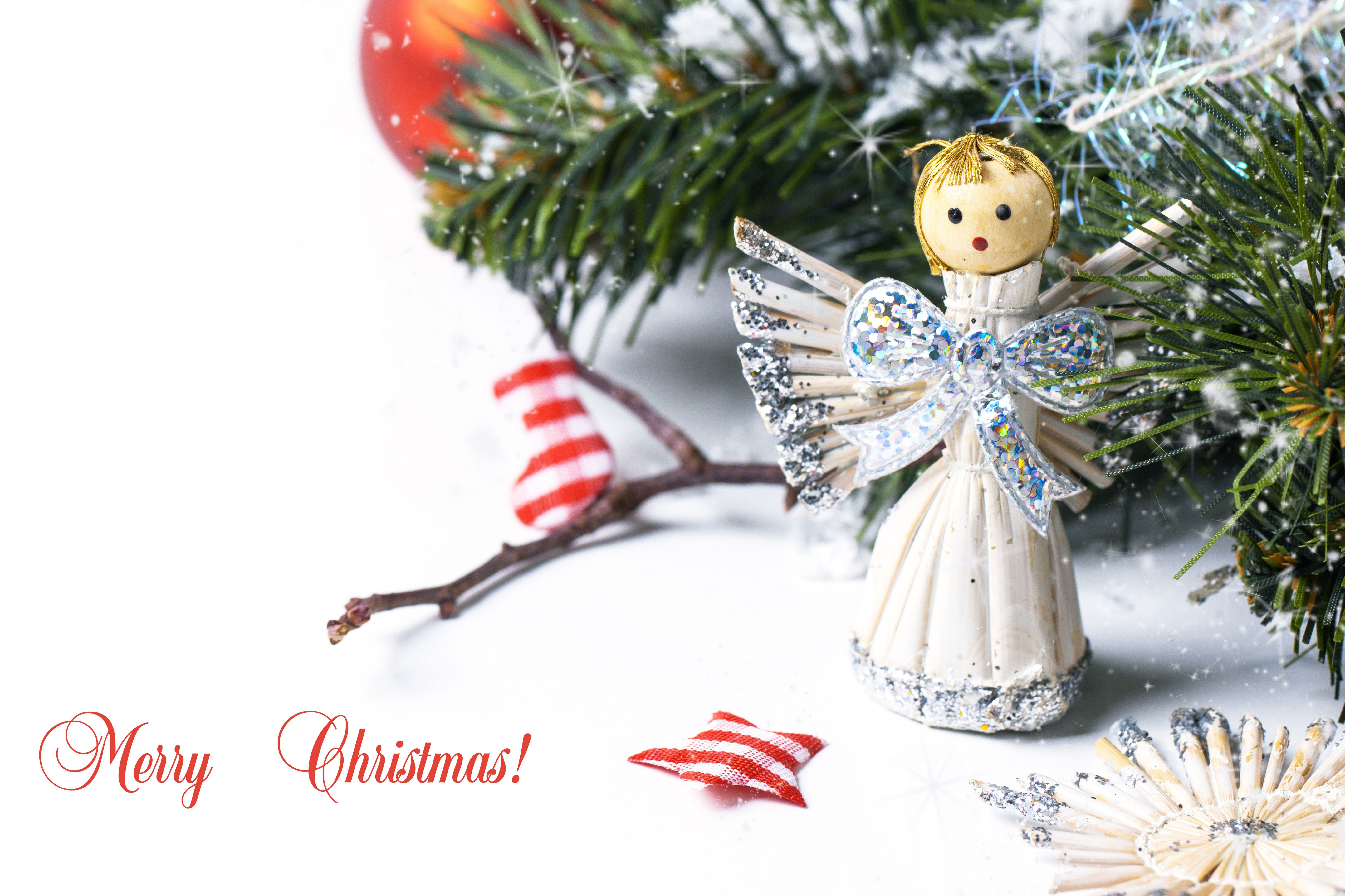 Christmas angel ornament with pine branches and red stocking HD Wallpaper