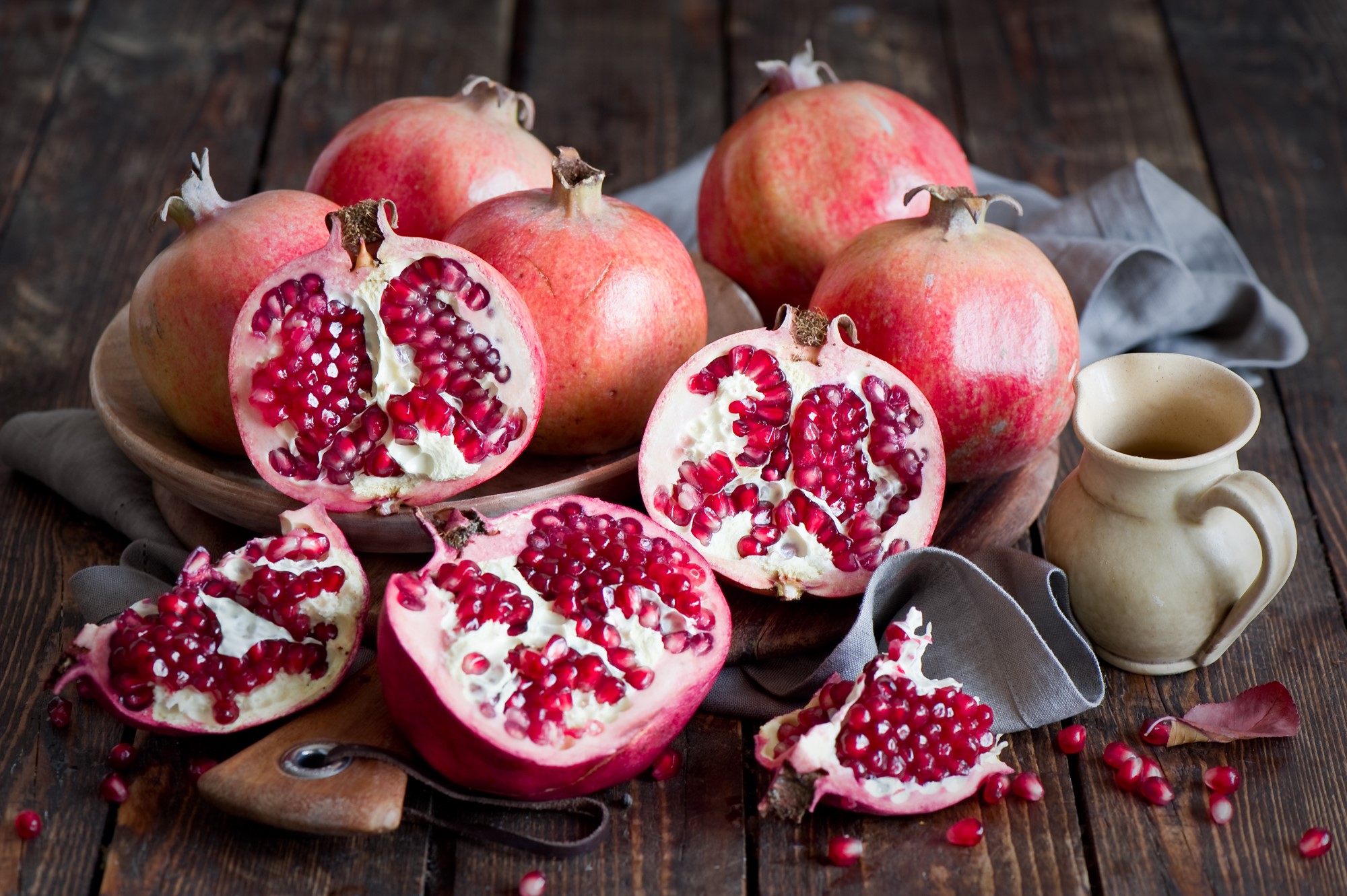 Pomegranates on a wooden table HD Wallpaper