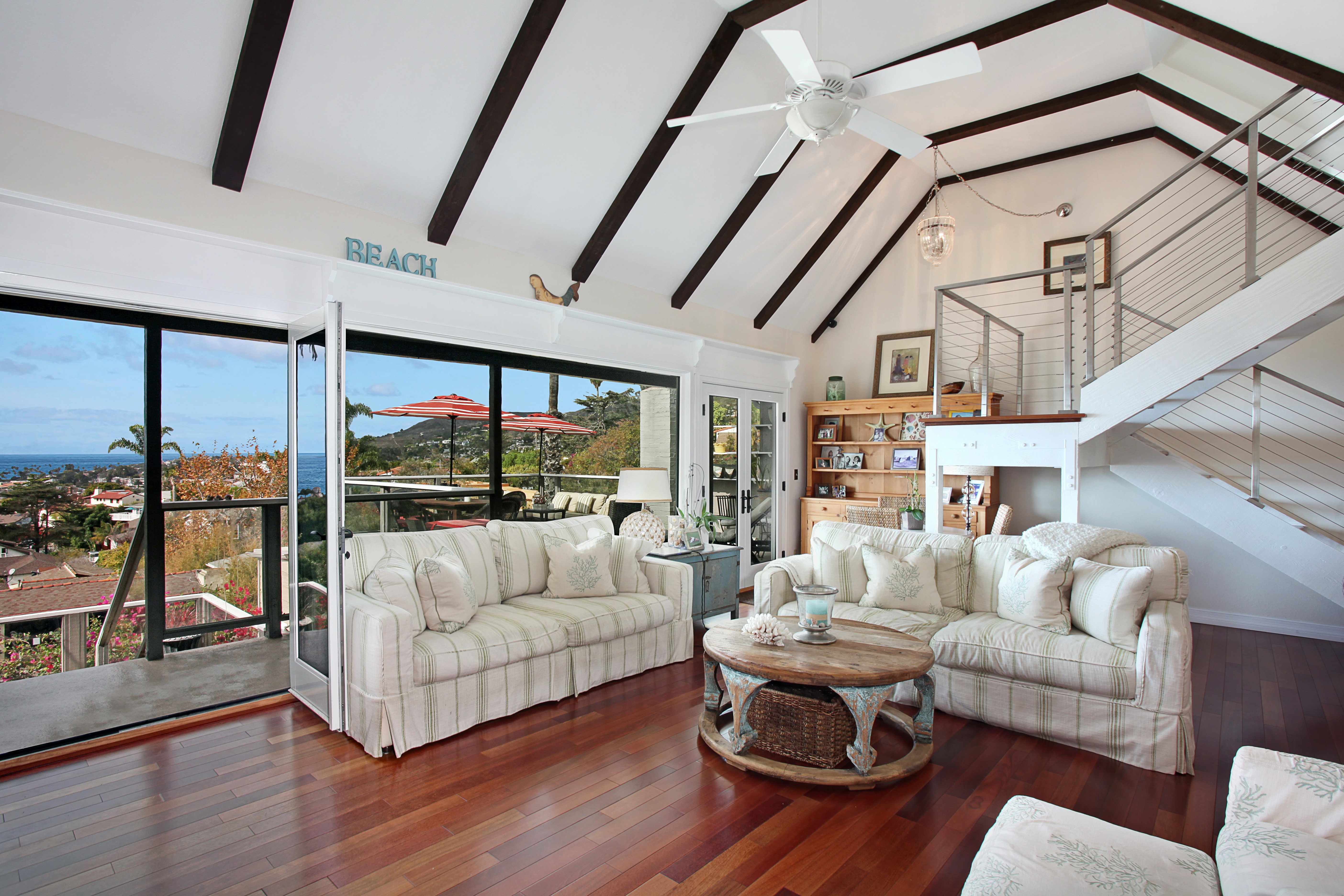 Living room with vaulted ceiling and ocean view HD Wallpaper