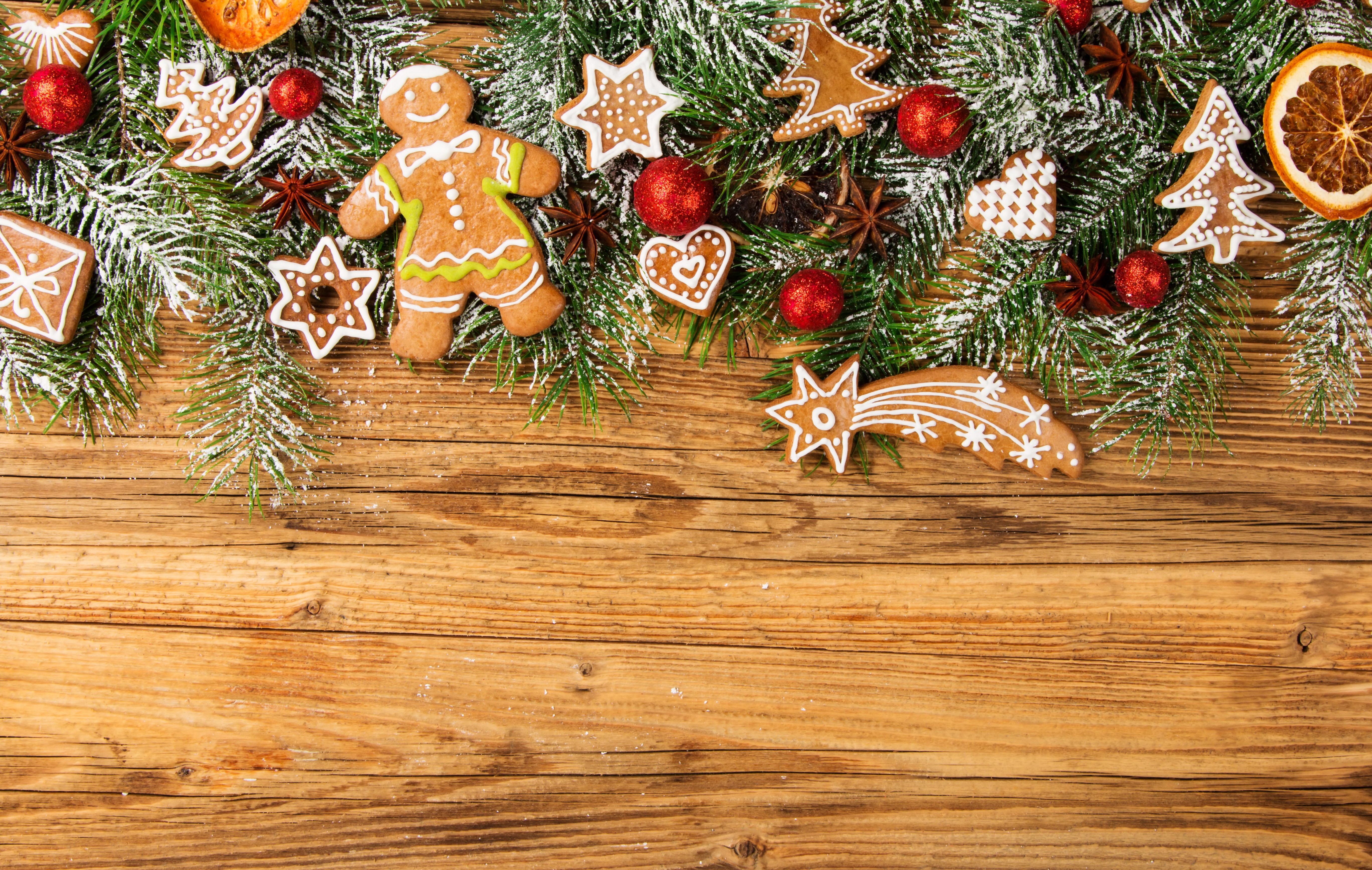 Christmas gingerbread cookies and pine branches on wood HD Wallpaper