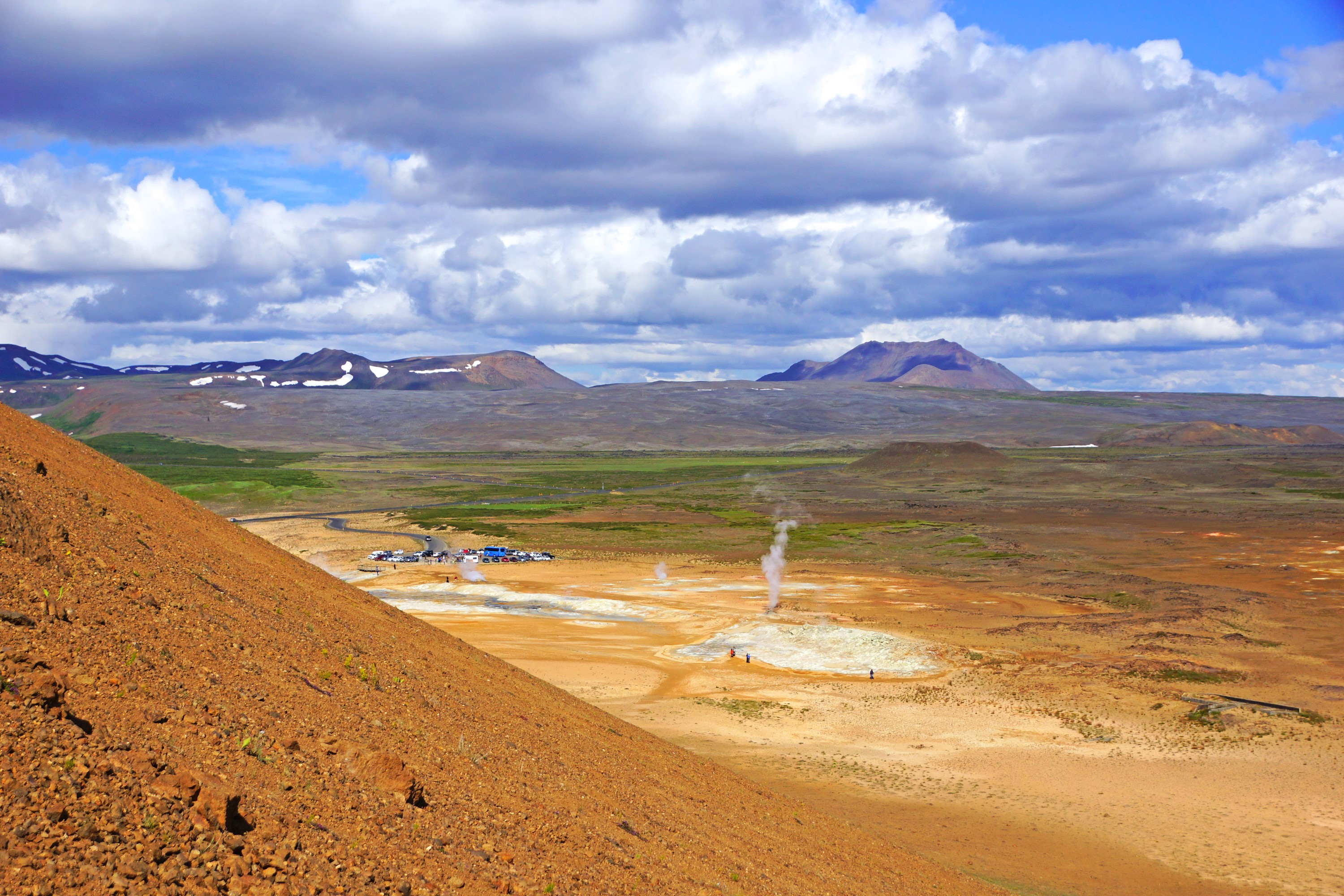 Geothermal area with steam vents and mountains in Iceland HD Wallpaper