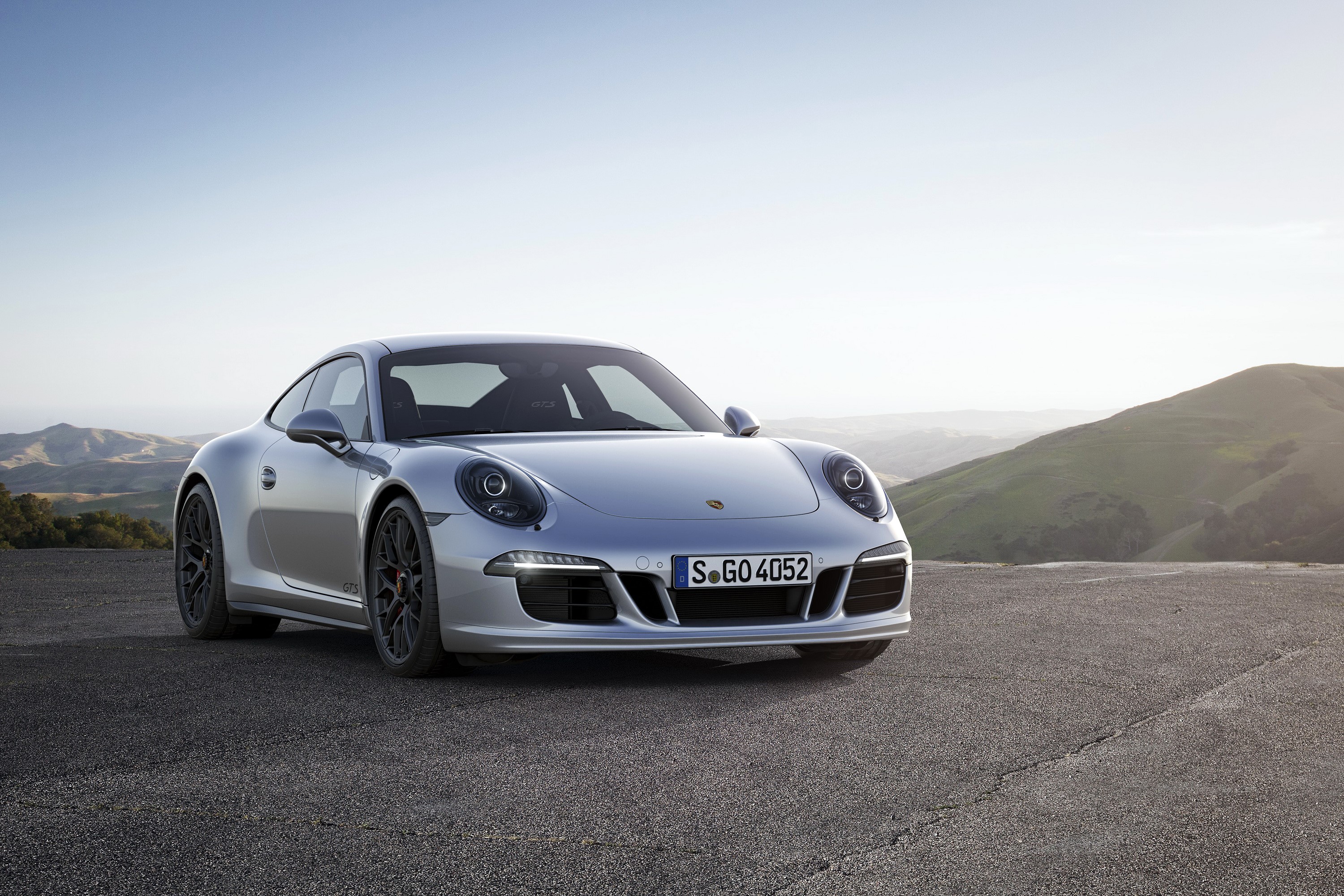 Silver Porsche 911 Carrera 4 GTS parked on a road HD Wallpaper