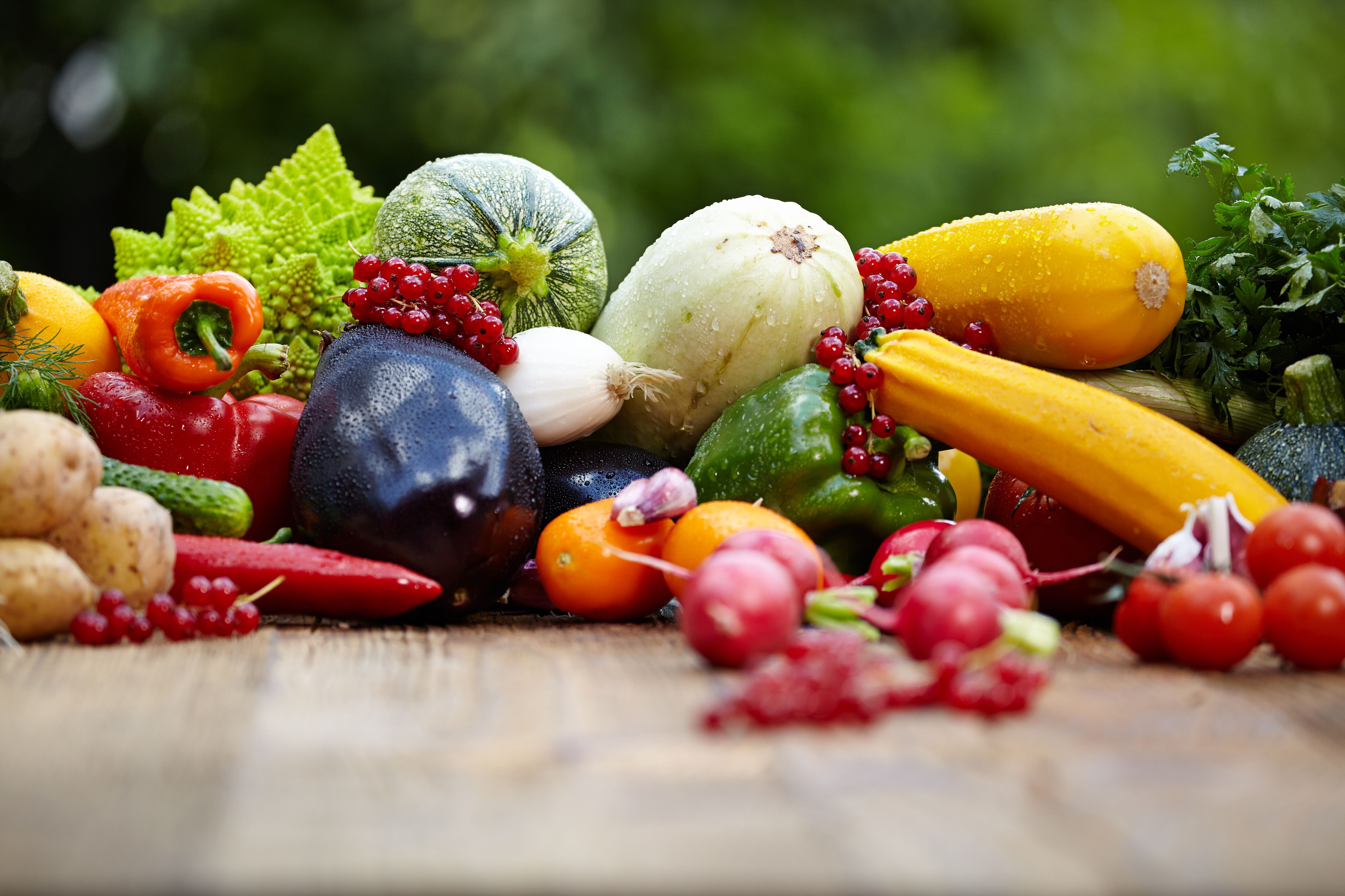 Assortment of fresh vegetables and fruits on a wooden table HD Wallpaper