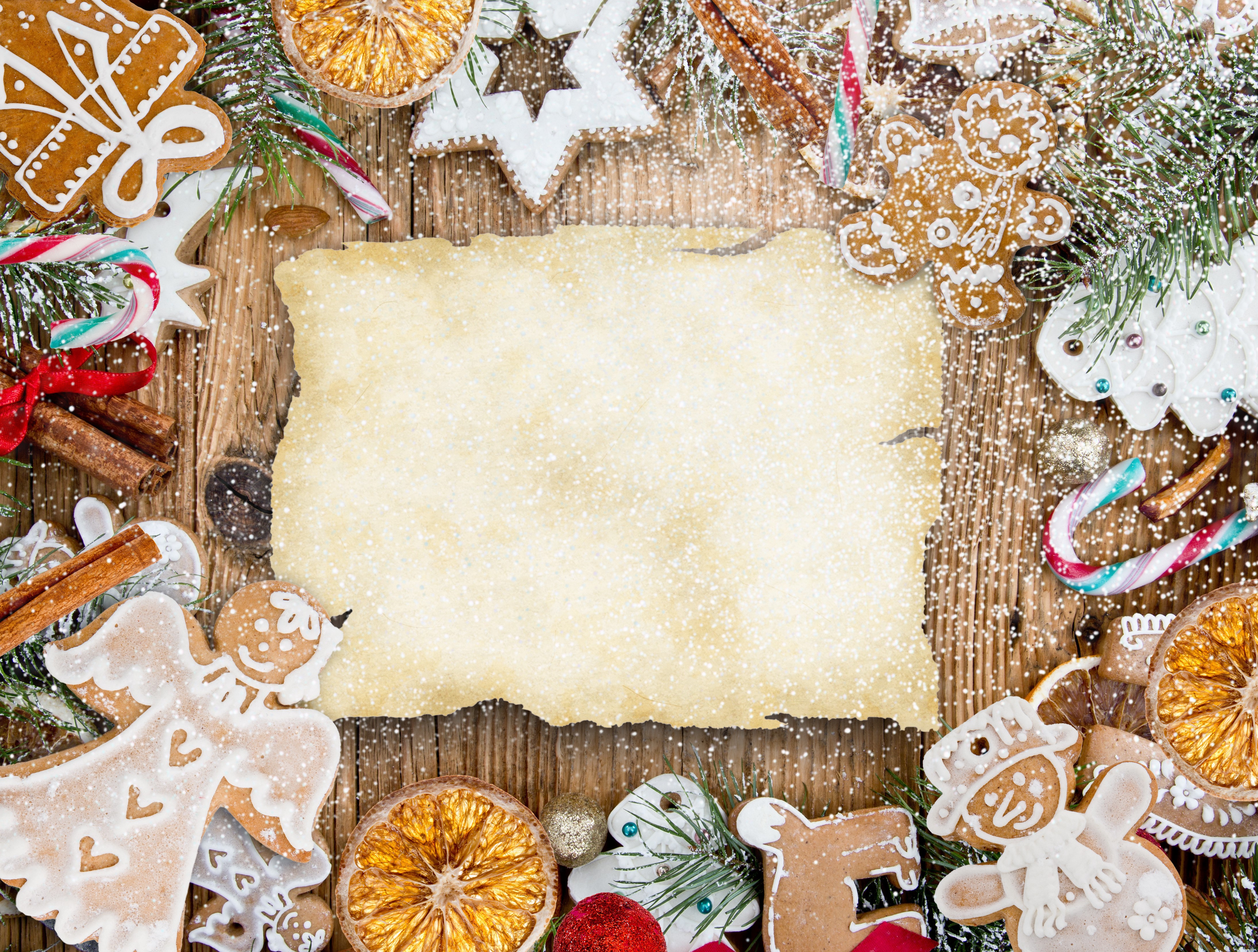 Christmas cookies and parchment on wooden table HD Wallpaper