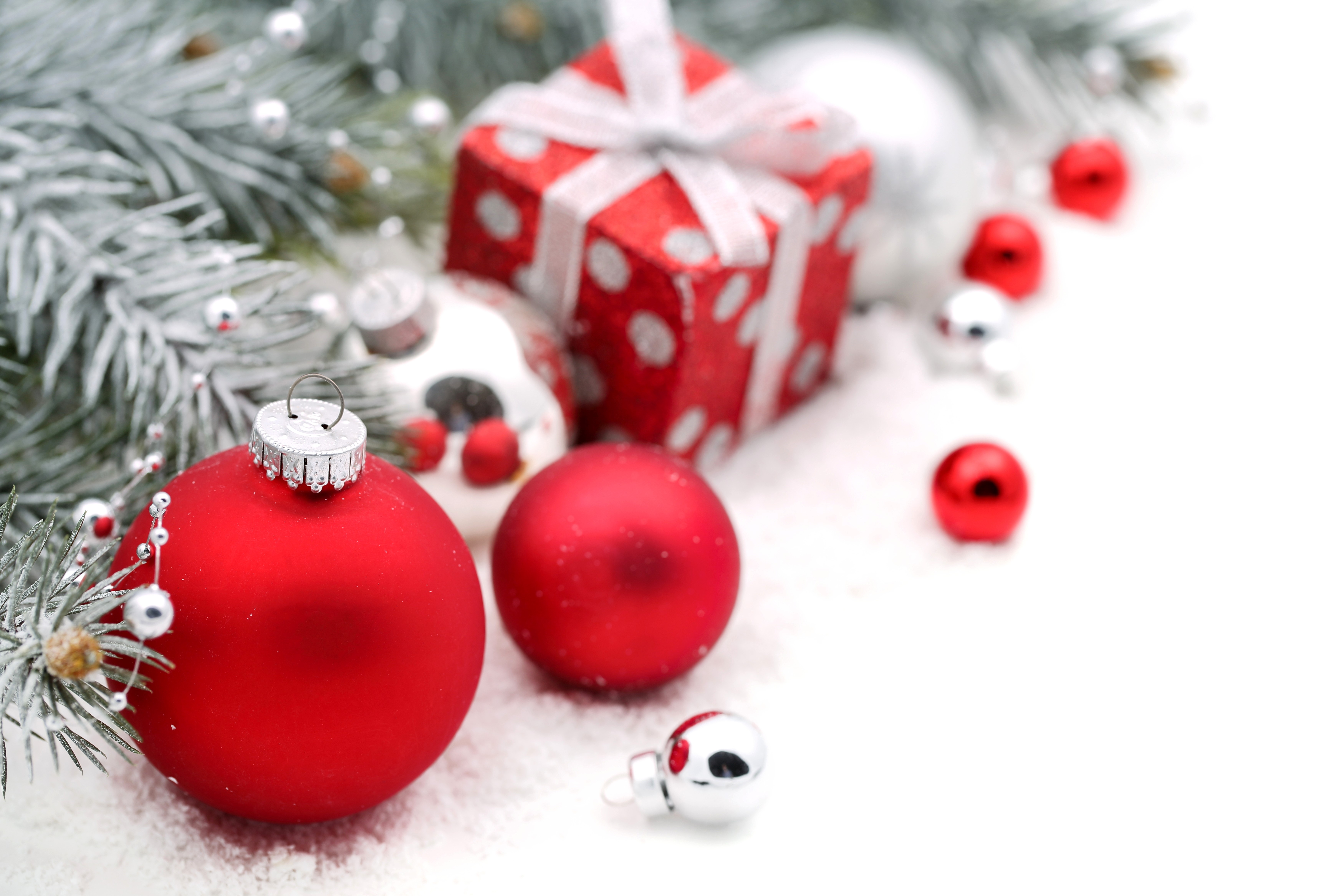 Christmas ornaments and gift with snow and pine branches HD Wallpaper