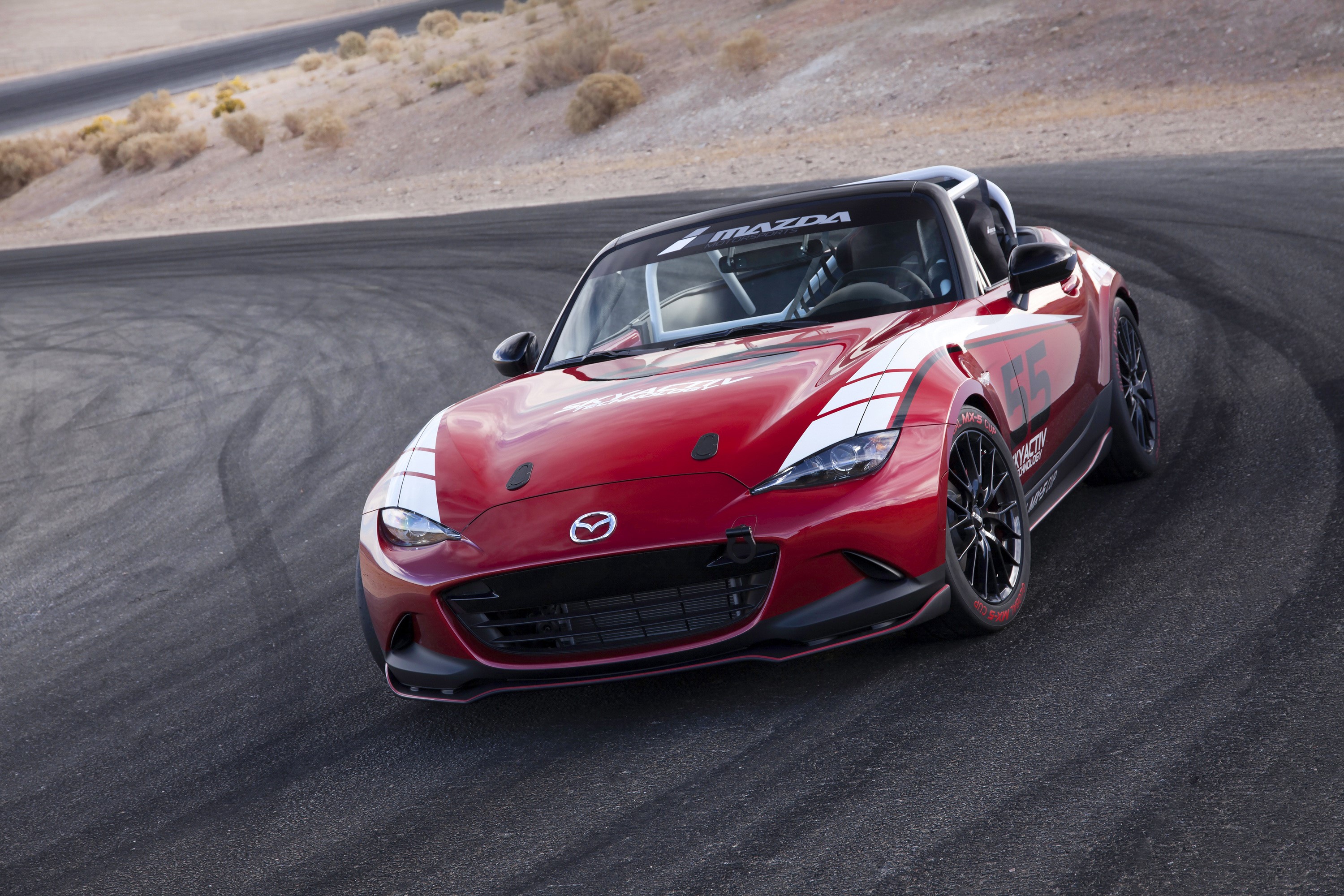 Red Mazda MX-5 Cup racecar on a track HD Wallpaper