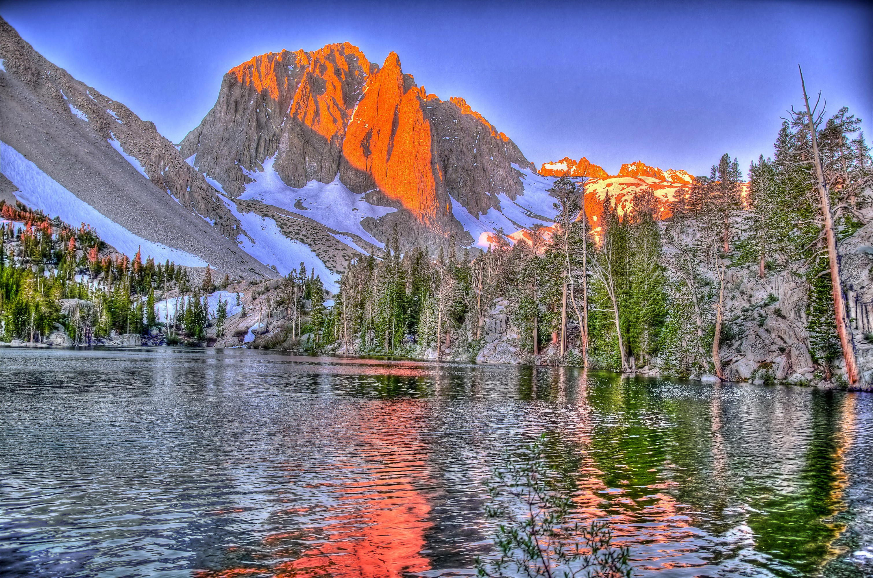 Mountain lake with trees and snow at sunset HD Wallpaper