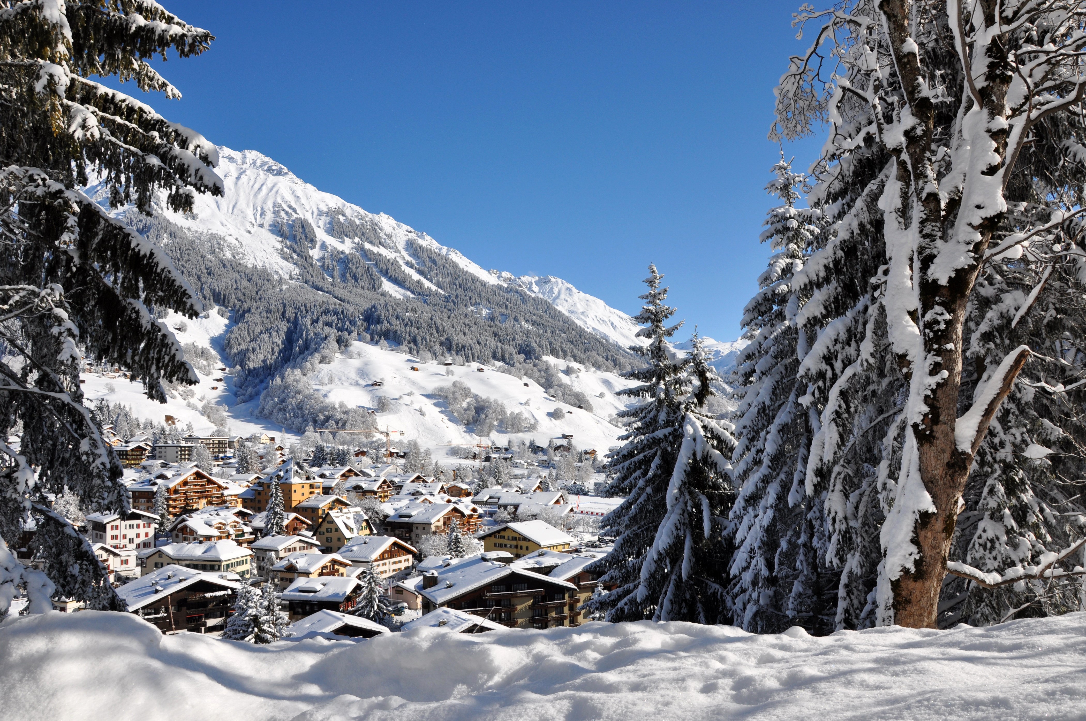 Klosters village in winter with snow-covered mountains HD Wallpaper