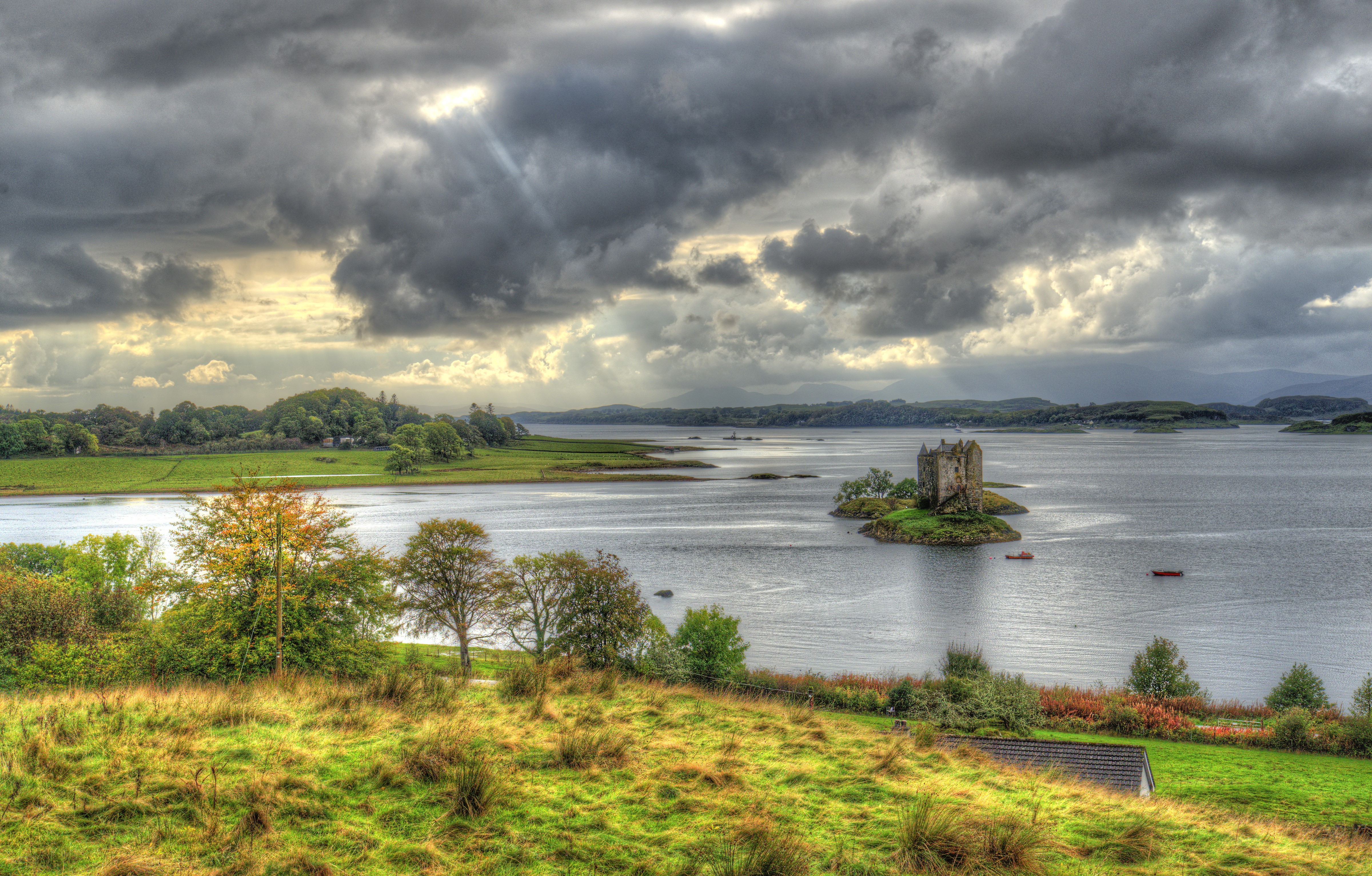 Castle Stalker on a small island in Scotland under cloudy skies HD Wallpaper
