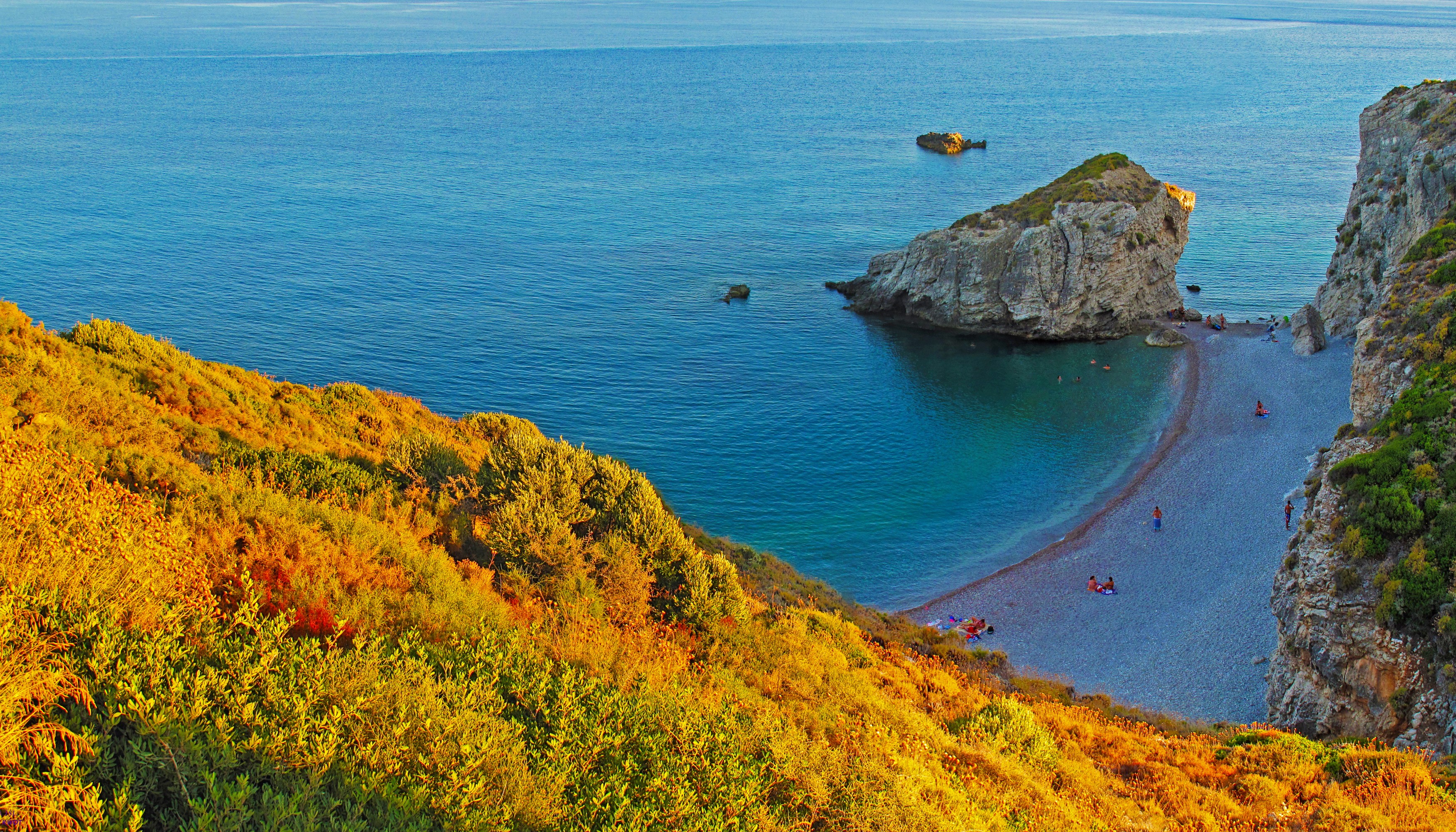 Kaladi Beach, Greece, with rocky outcrops and clear blue sea HD Wallpaper