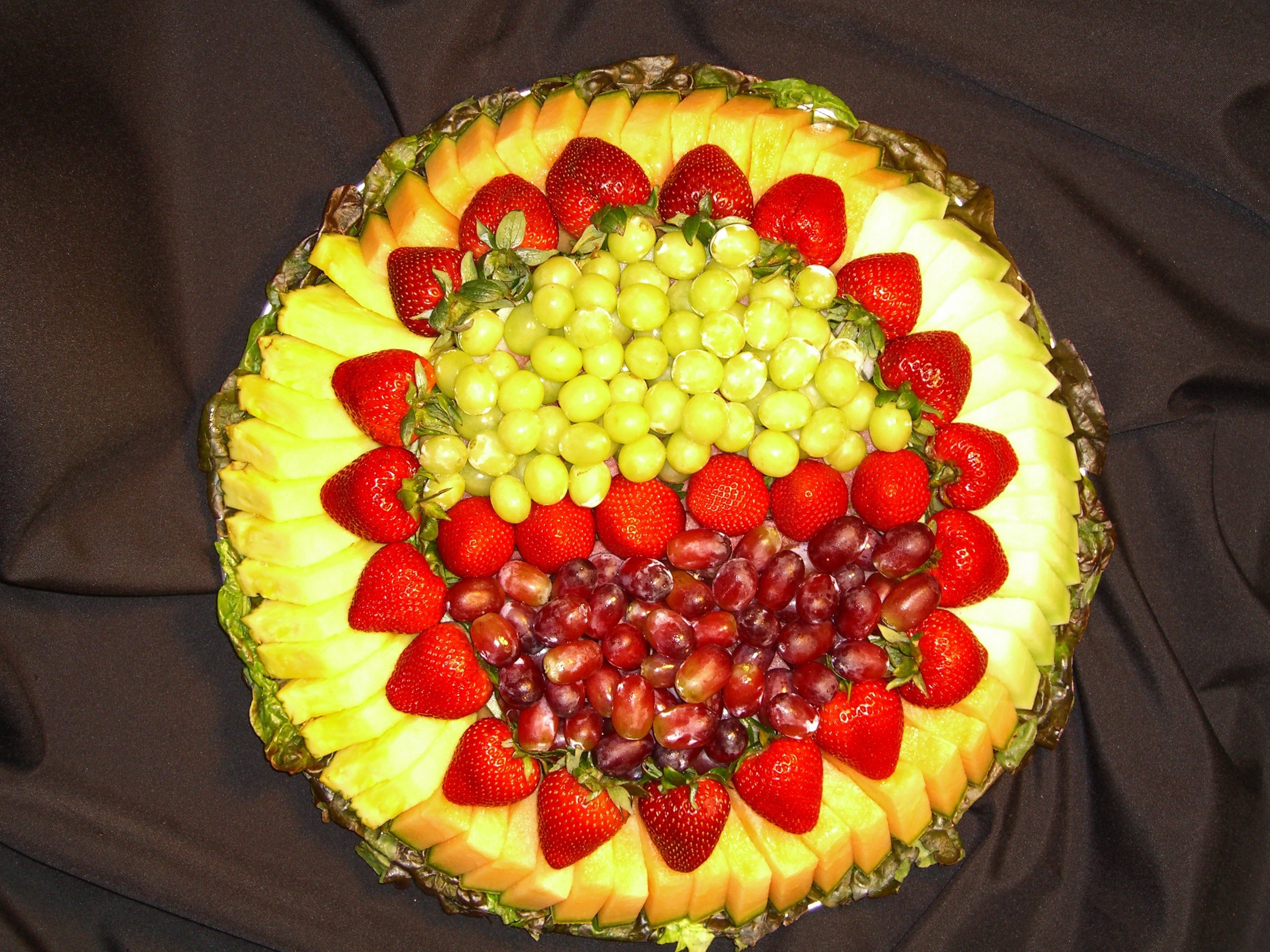 Fruit platter with pineapple, strawberries, and grapes HD Wallpaper