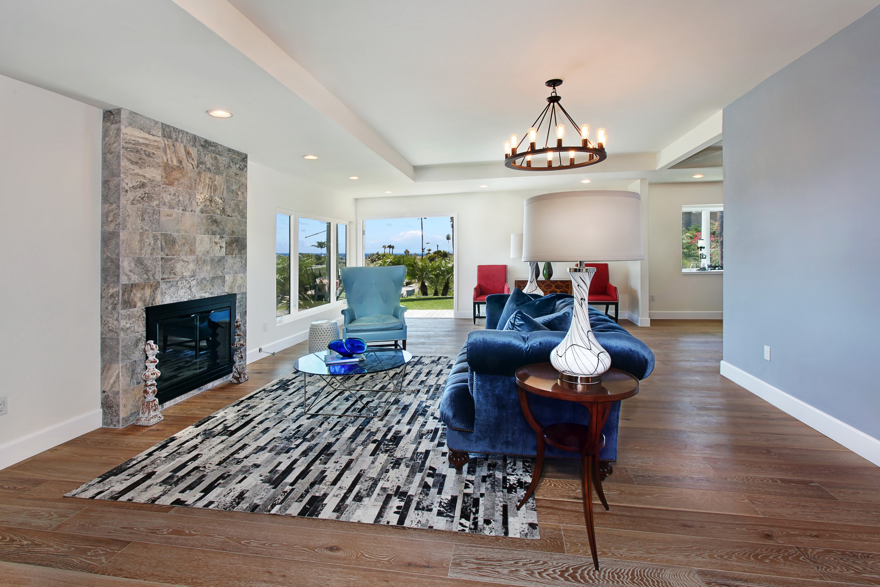 Living room with fireplace, chandelier, and sofa HD Wallpaper
