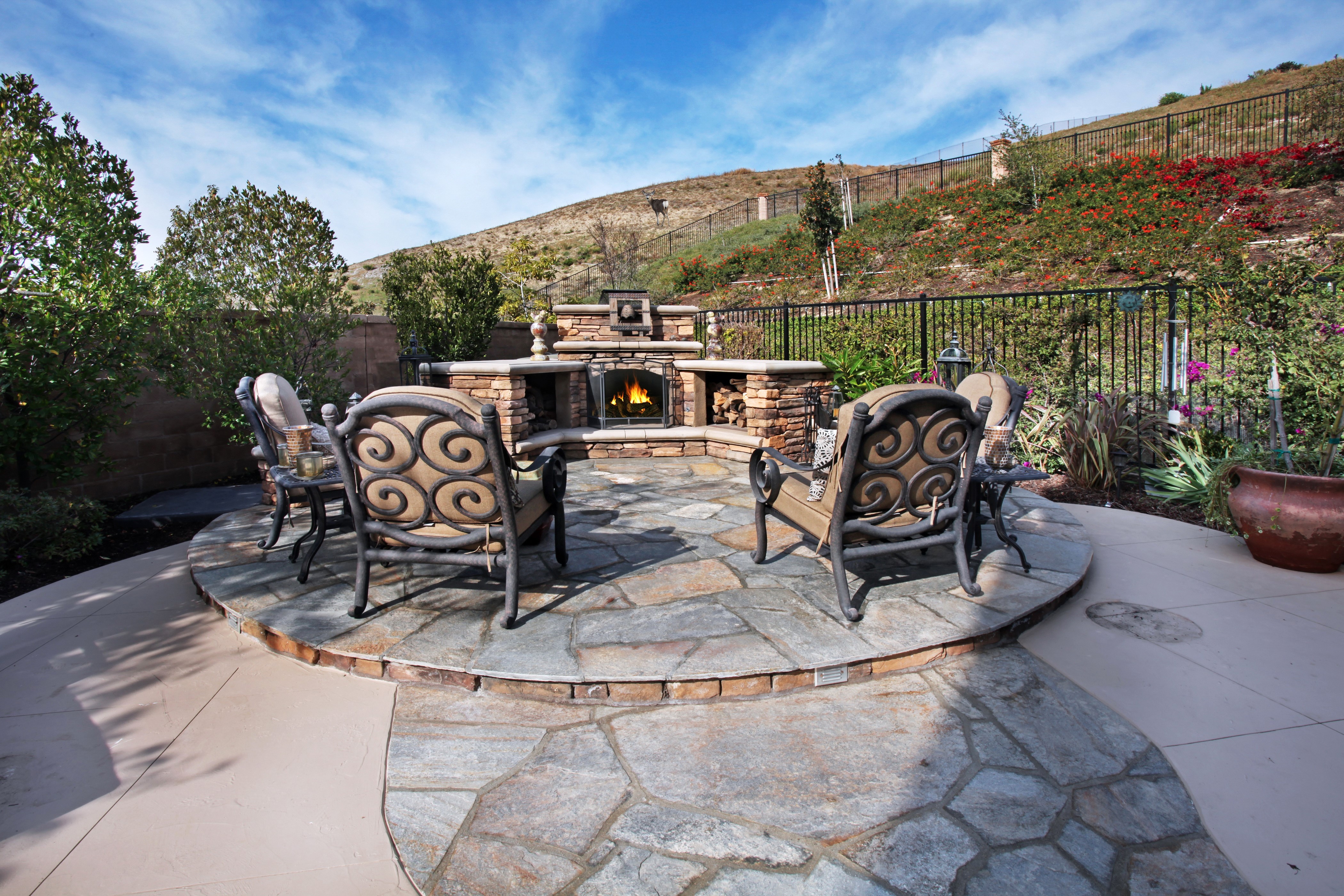 Outdoor Living Area with Fireplace and Chairs HD Wallpaper
