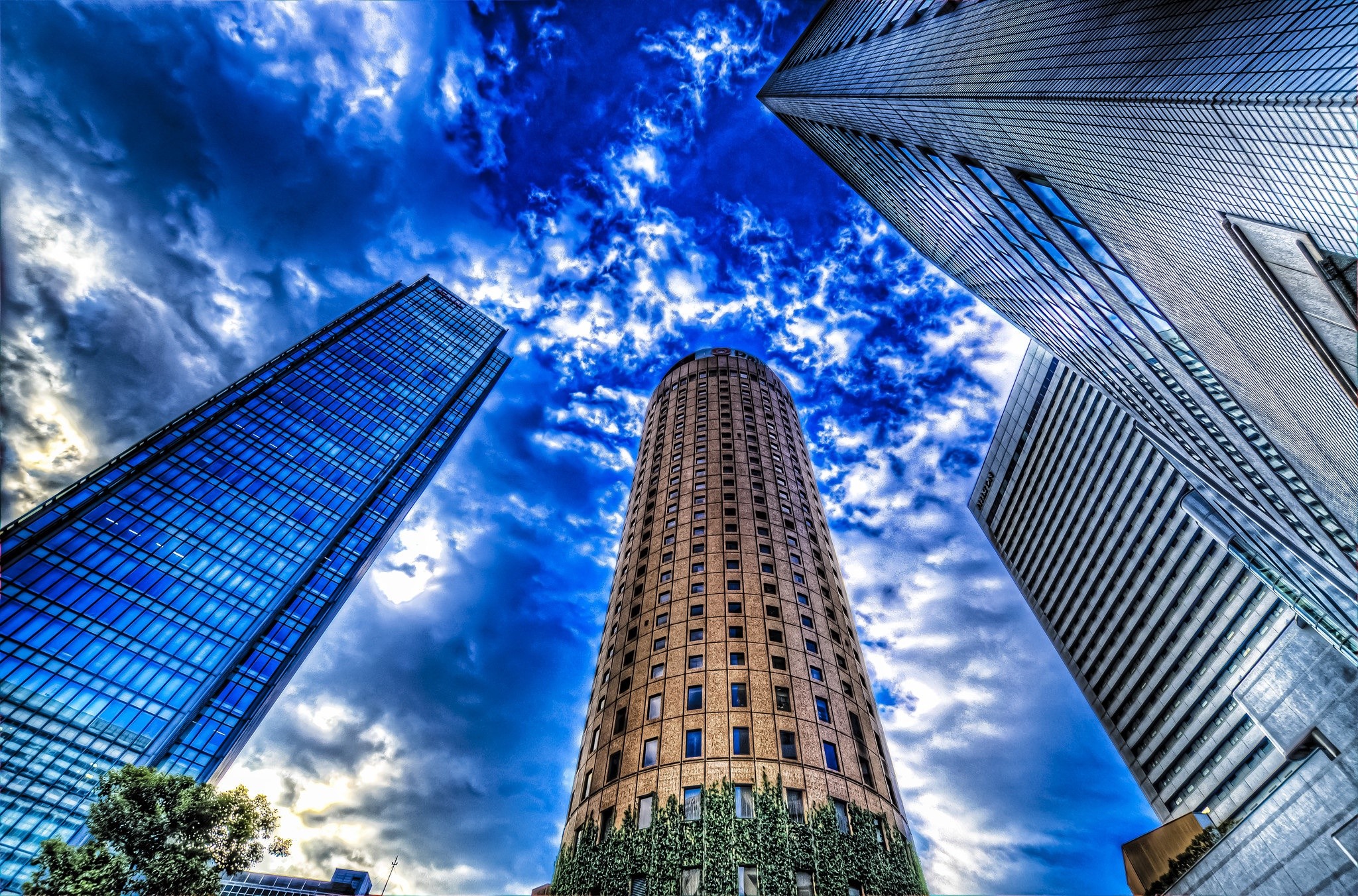 Skyscrapers against a dramatic blue sky HD Wallpaper