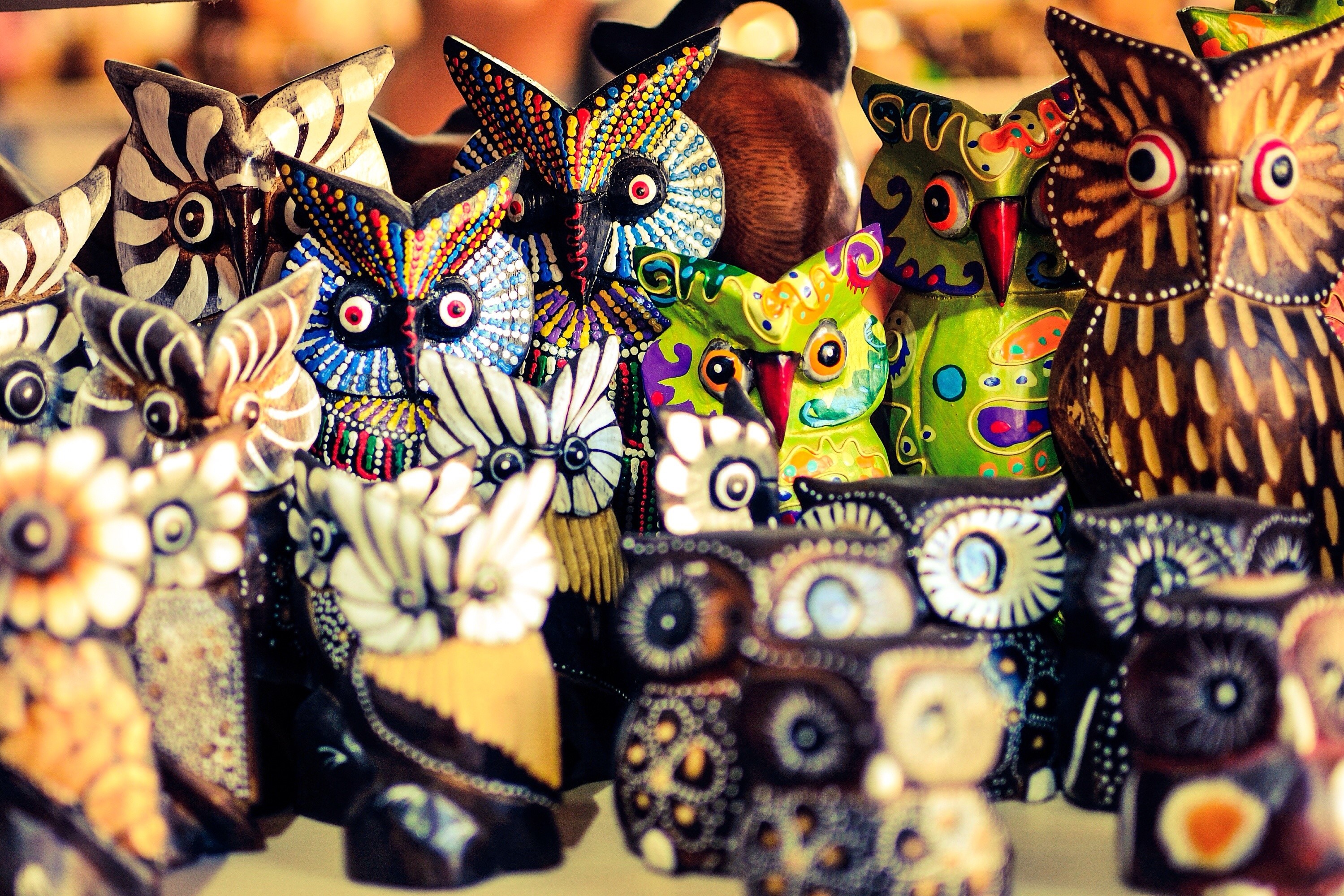 Colorful wooden owl figurines displayed for sale HD Wallpaper