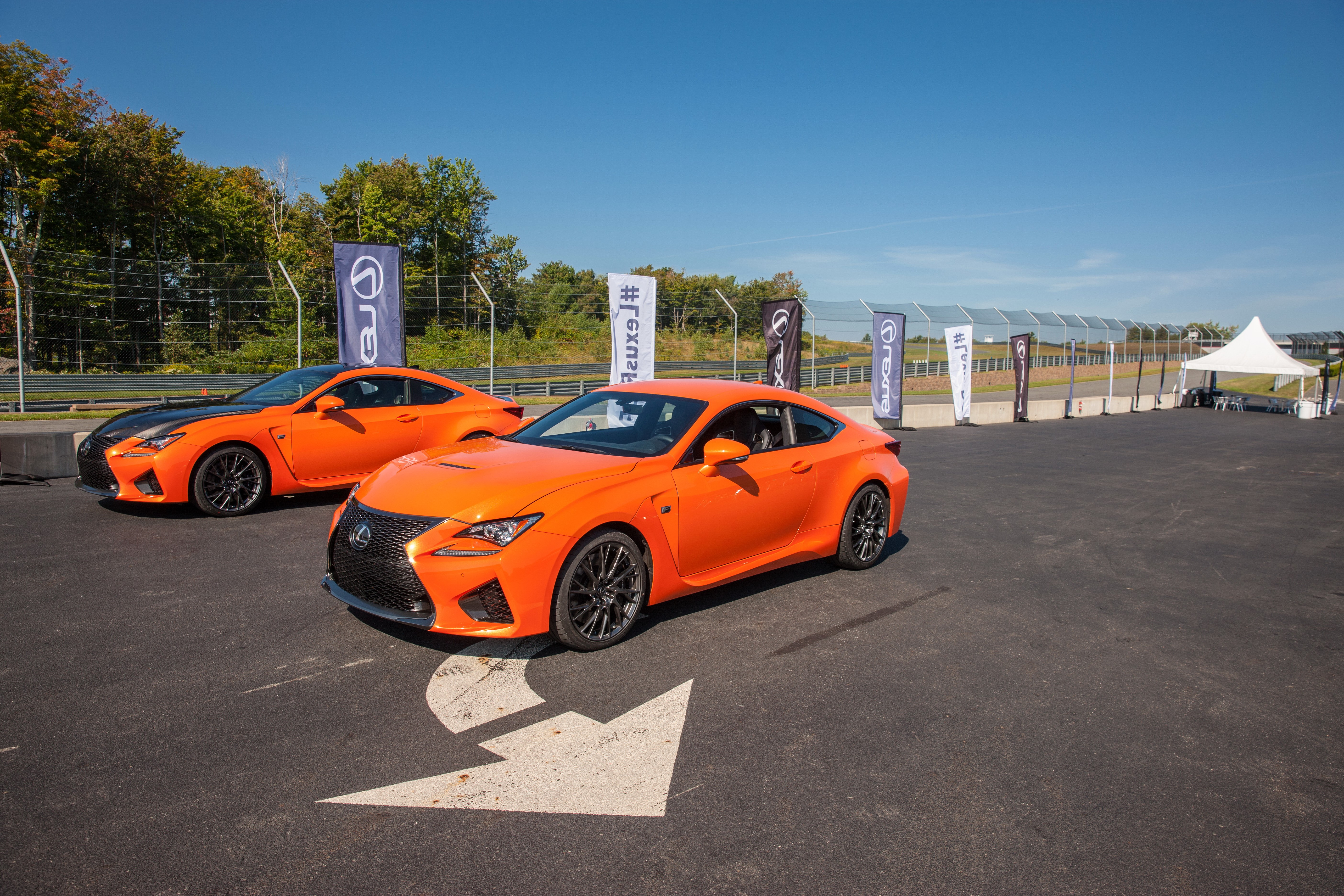Two orange Lexus RC F cars on a track HD Wallpaper
