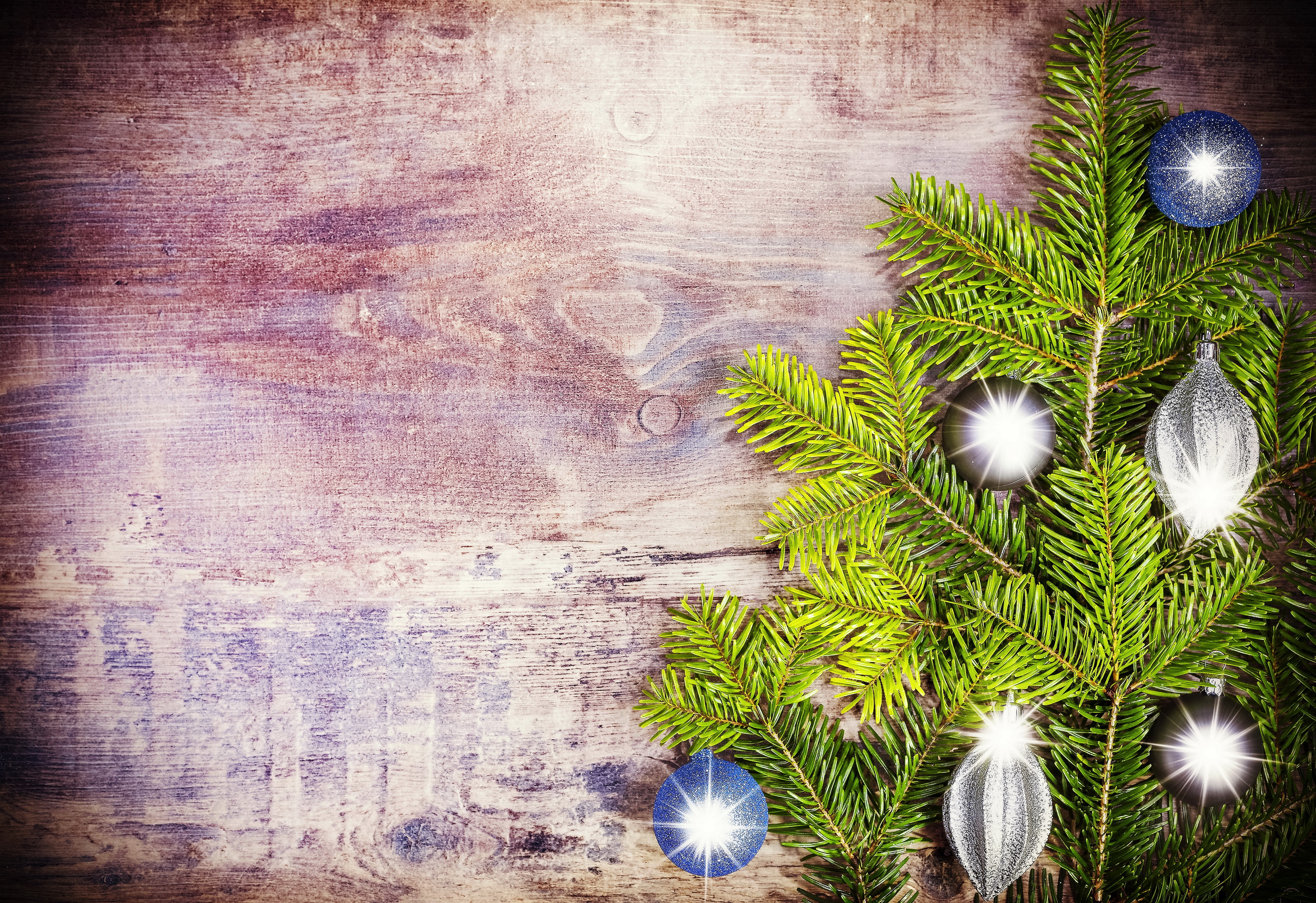 Christmas tree branches with ornaments on wooden background HD Wallpaper