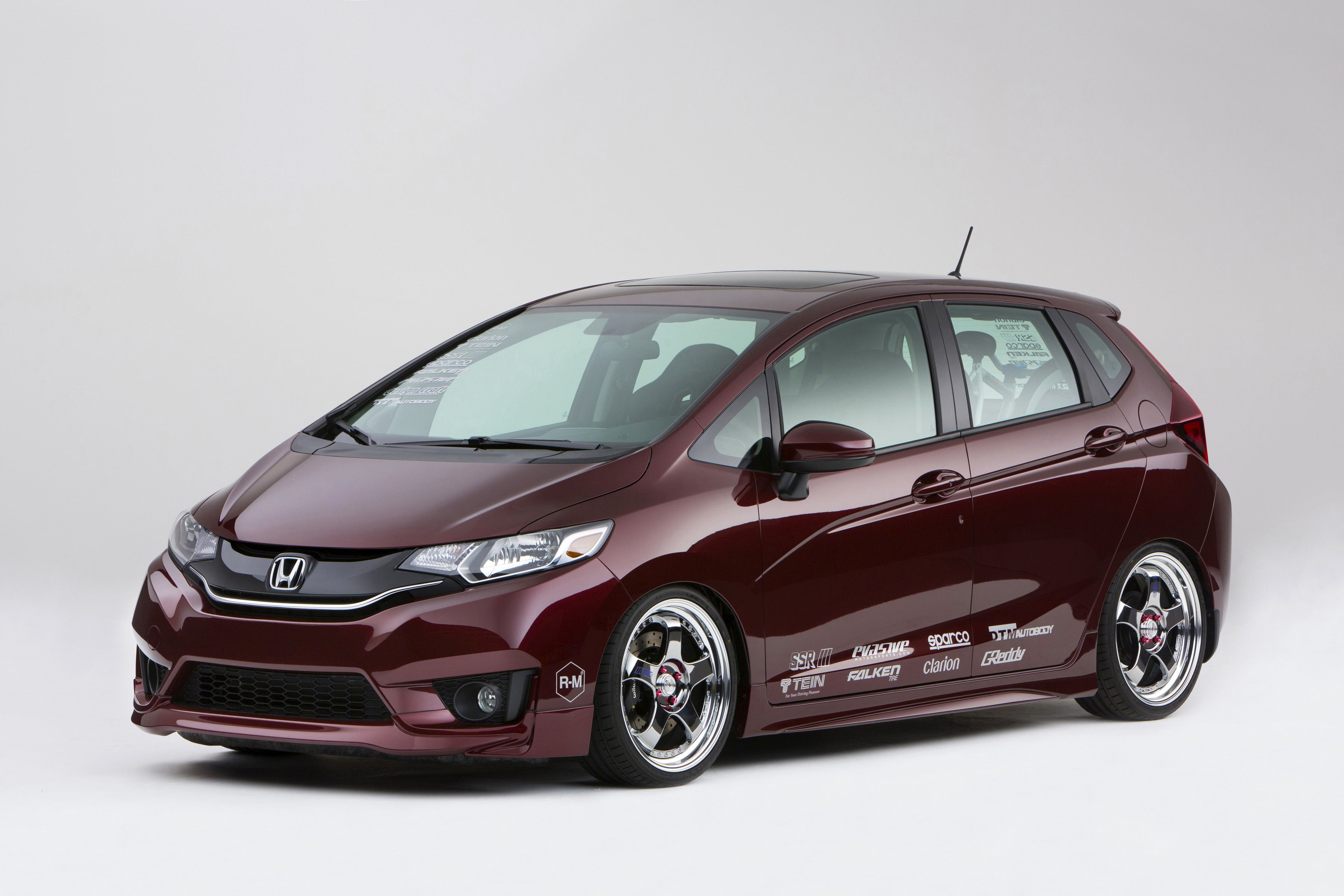 Honda Fit with racing decals and custom wheels HD Wallpaper