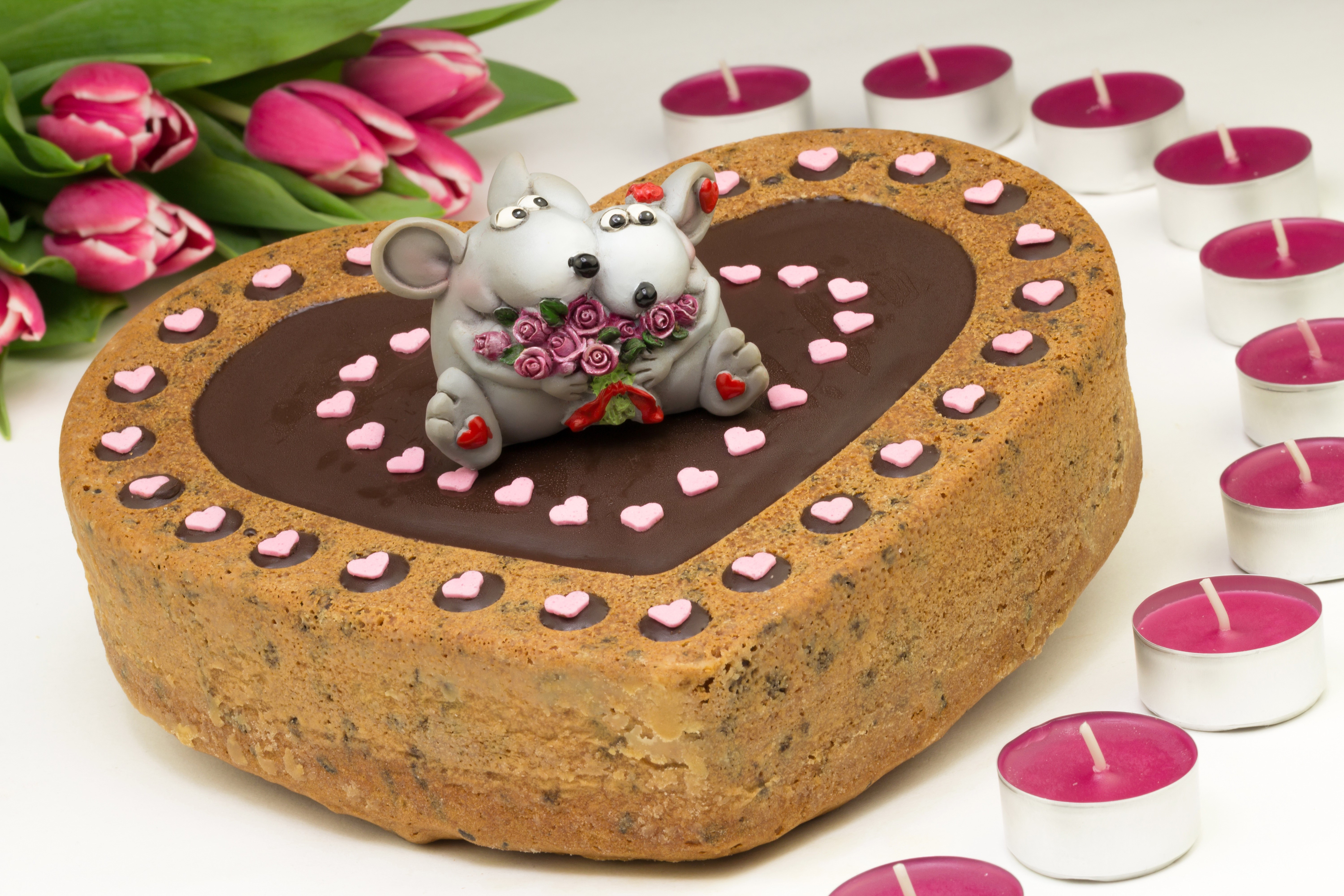 Heart-shaped cake with mice figures, tulips, and candles HD Wallpaper