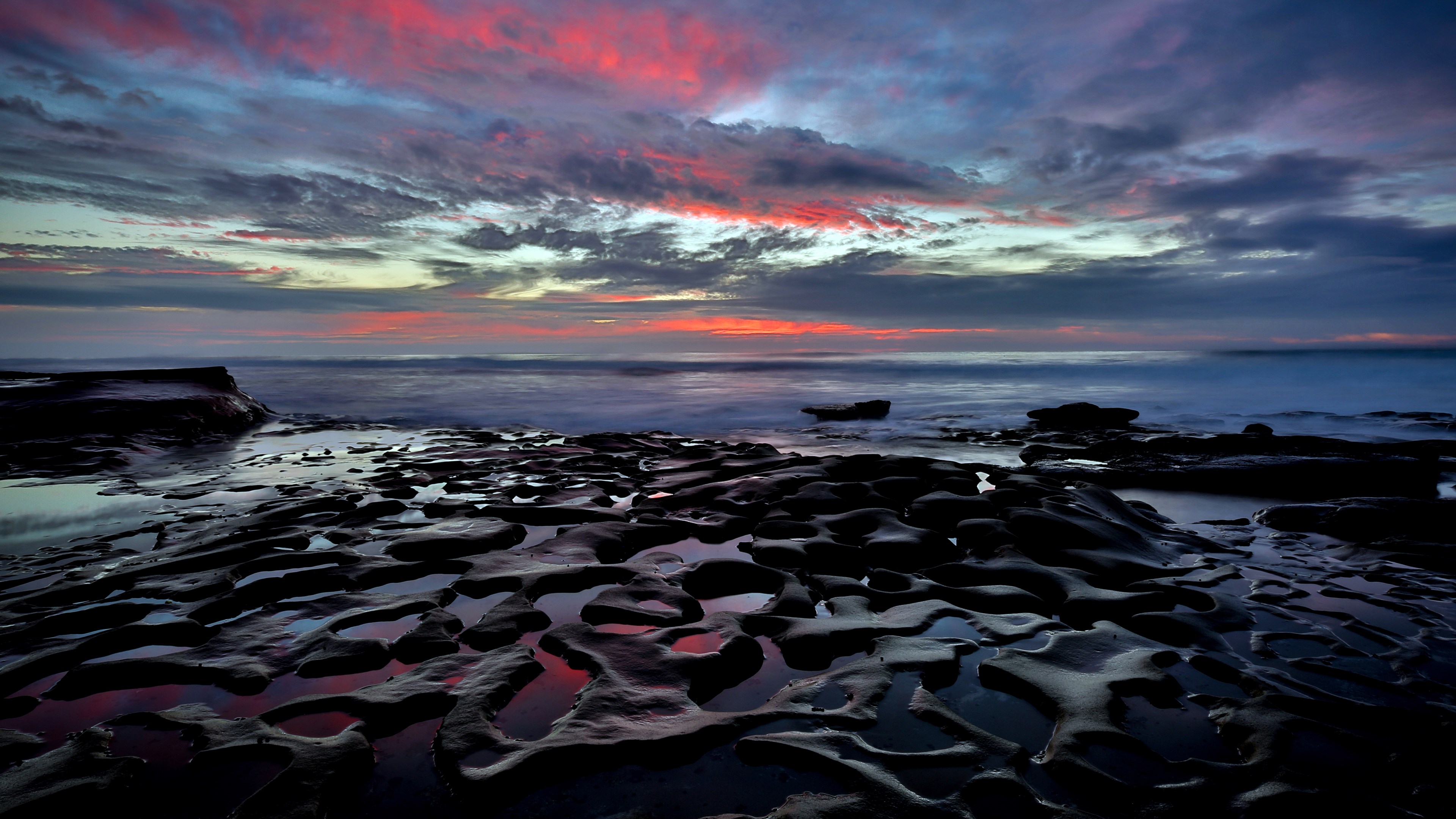 Rocky Shoreline at Sunset with Colorful Clouds HD Wallpaper