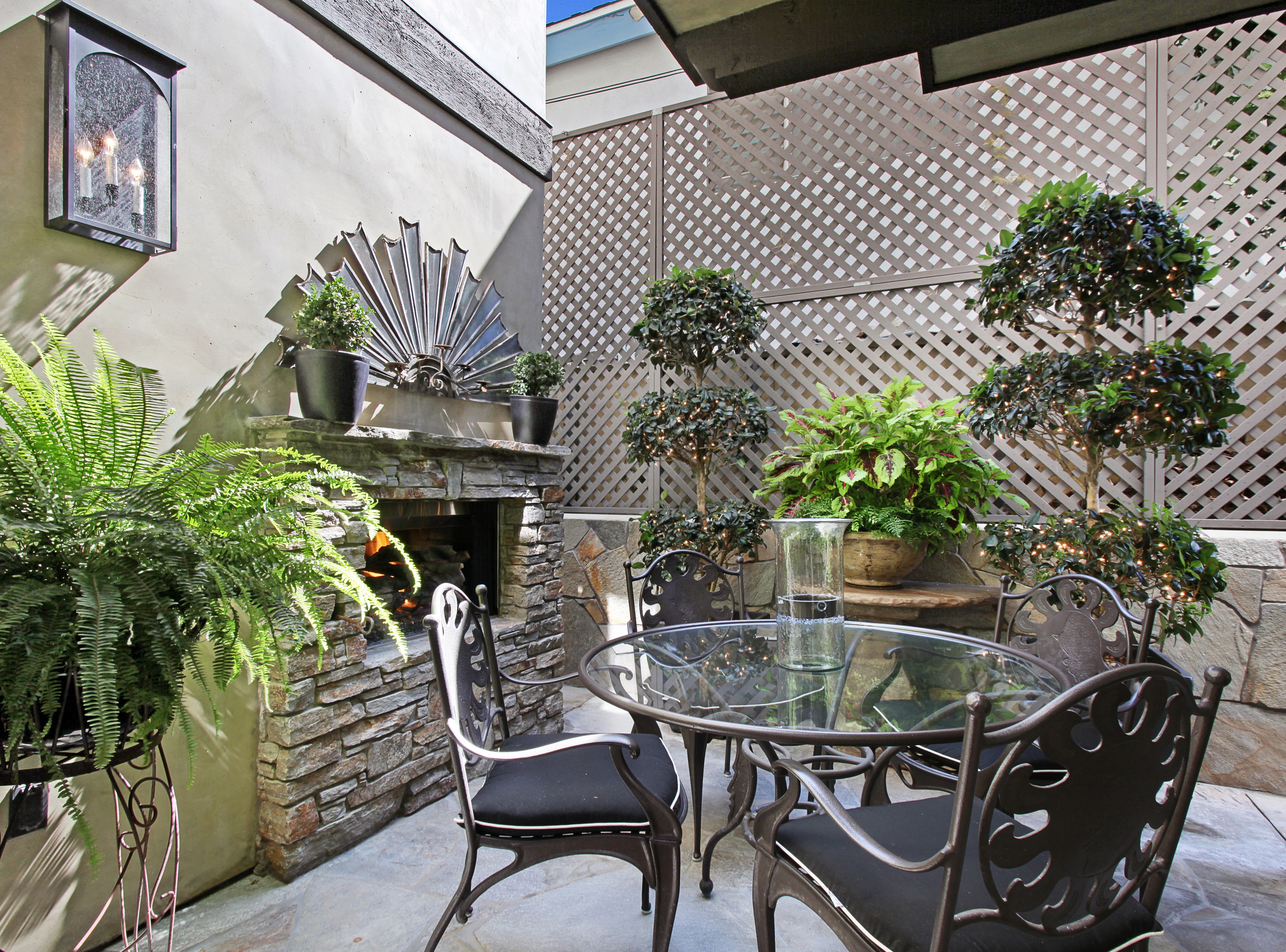 Outdoor Patio with Fireplace, Table, and Chairs HD Wallpaper