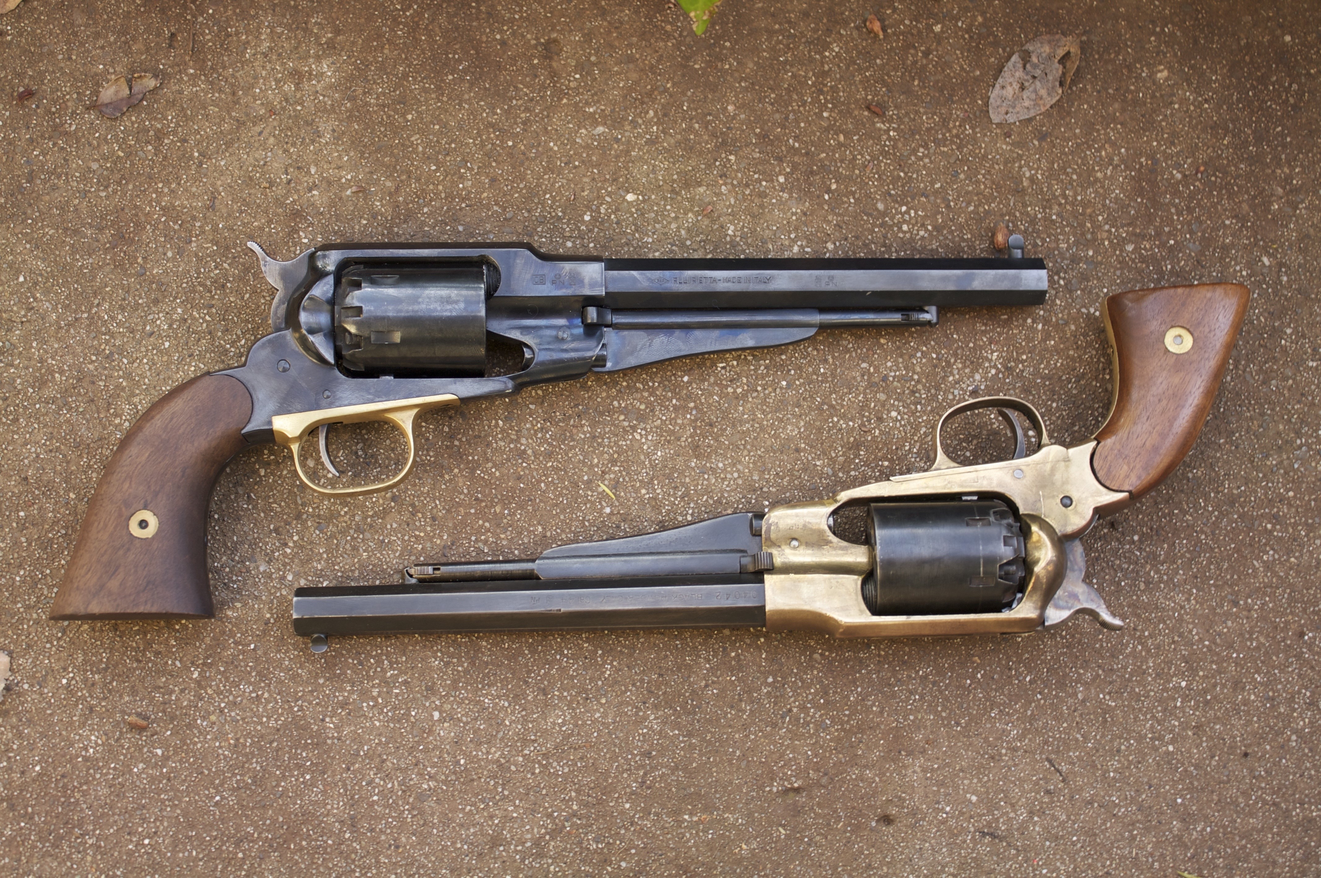 Two antique revolvers on a concrete surface HD Wallpaper