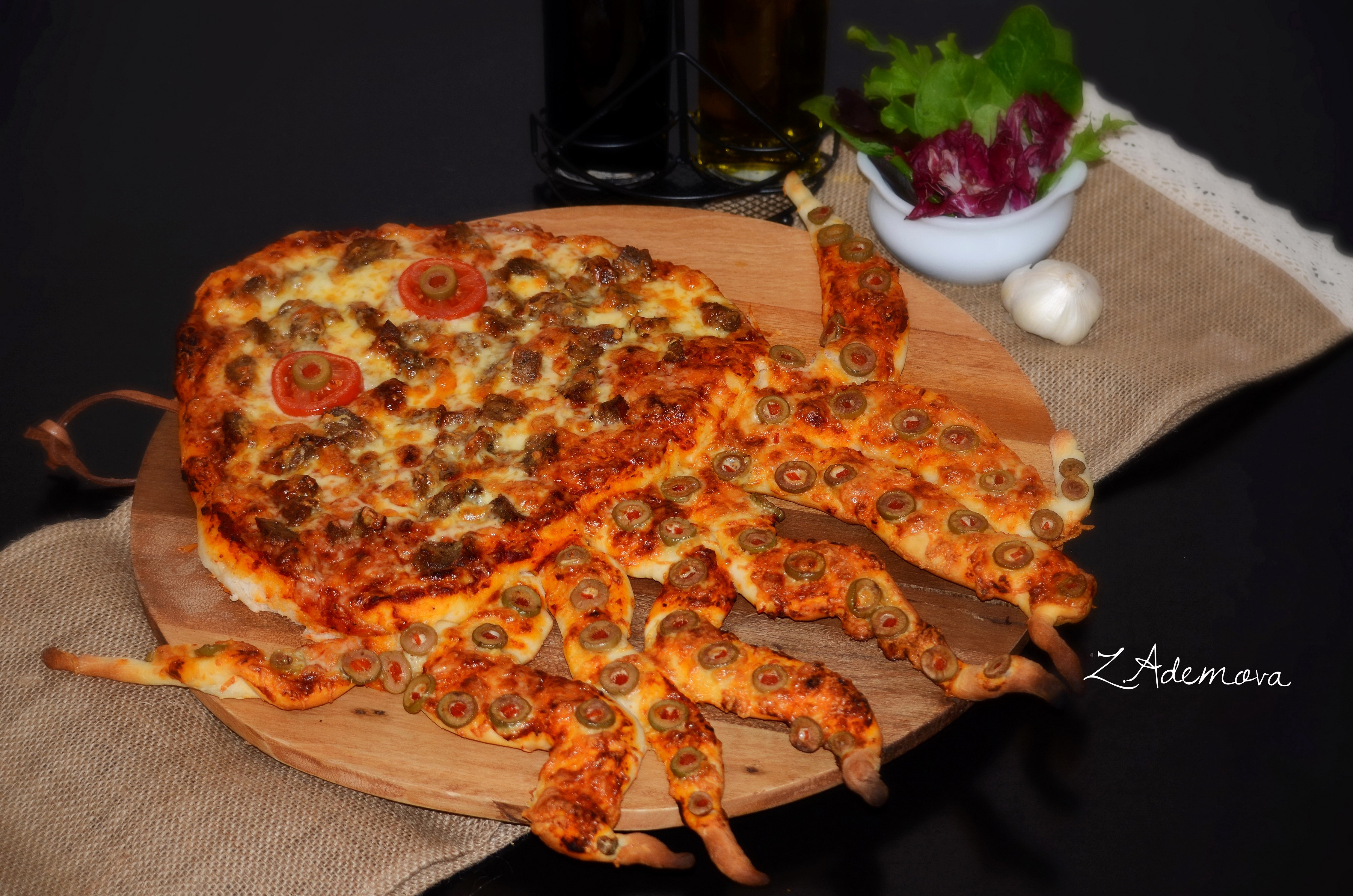 Octopus-shaped pizza with olives and tomatoes HD Wallpaper